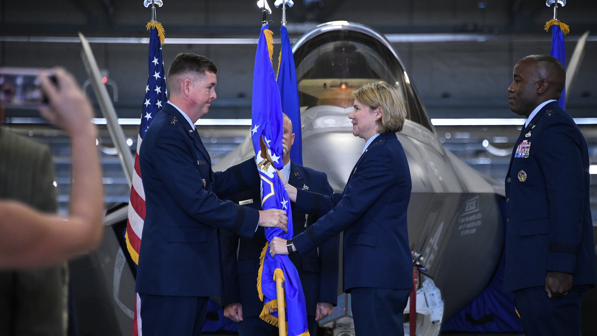 Lt. Gen. Donald Kirkland, Air Force Sustainment Center commander, passes the guidon to Brig. Gen. C. McCauley von Hoffman, incoming Ogden Air Logistics Complex commander, during a change of command ceremony July 19, 2019, at Hill Air Force Base, Utah.