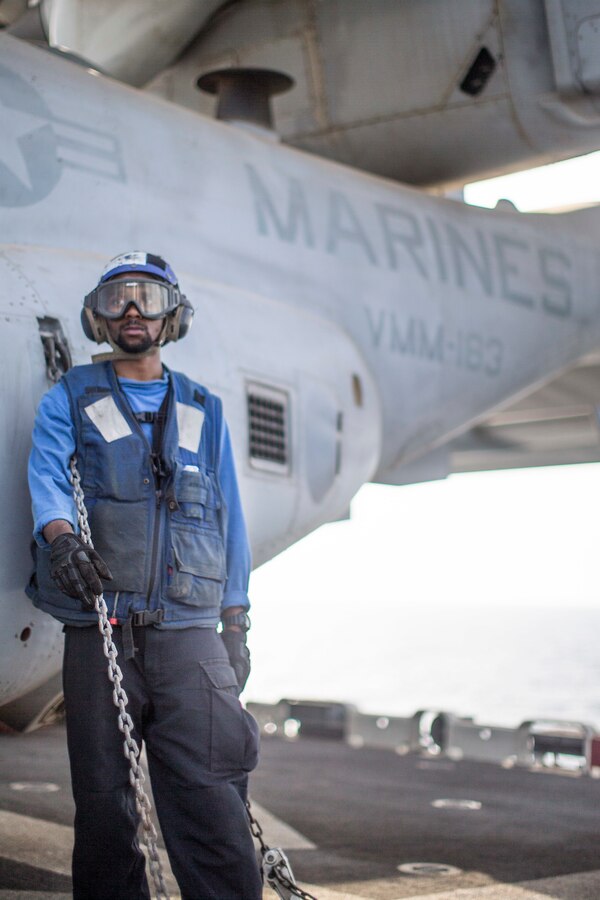 GULF OF ADEN (July 3, 2019) U.S. Navy Aviation Boatswain’s Mate Airman 3rd Class Cornell Pradier, assigned to the amphibious assault ship USS Boxer (LHD 4), stands near an MV-22 Osprey with Marine Medium Tiltrotor Squadron (VMM) 163 (Reinforced), 11th Marine Expeditionary Unit (MEU), during flight operations. The Boxer Amphibious Ready Group and the 11th MEU are deployed to the U.S. 5th Fleet area of operations in support of naval operations to ensure maritime stability and security in the Central Region, connecting the Mediterranean and the Pacific through the Western Indian Ocean and three strategic choke points. (U.S. Marine Corps photo by Lance Cpl. Dalton Swanbeck)