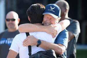 Basic cadet is hugged by family member