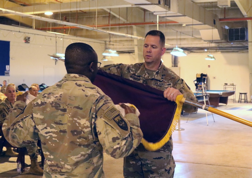 Col. Jeffrey McCarter, 8th Medical Brigade commander, cases the colors with Command Sgt. Maj. Ekondua Amoke during a transfer of authority ceremony with the 3d Medical Command Deployment Support -  Forward at Camp As Sayliyah, Qatar, July 18, 2019.