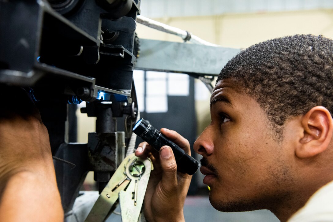 Senior Airman James Jennings, 23d Maintenance Squadron armament (ARMs) flight gun element member, performs an inspection on a 30mm GAU-8 gatling gun system, July 17, 2019, at Moody Air Force Base, Ga. The ARMs shop primarily performs quality armament systems maintenance and inspections to provide aircrews with safe and reliable weapon systems for lethal airpower employment. (U.S. Air Force photo by Senior Airman Erick Requadt)