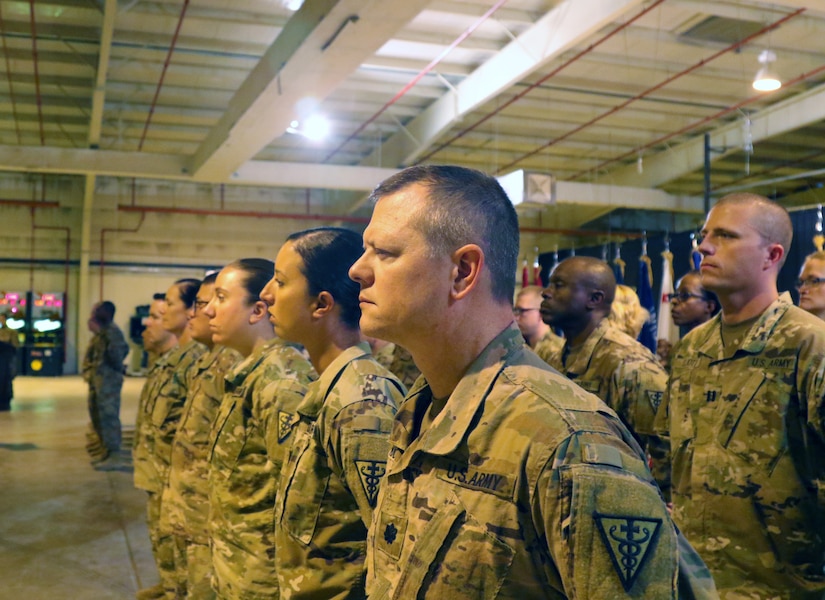 Soldiers of 3d Medical Command Deployment Support - Forward stand in formation during a transfer of authority ceremony with the 8th Medical Brigade at Camp As Sayliyah, Qatar, July 18, 2019.