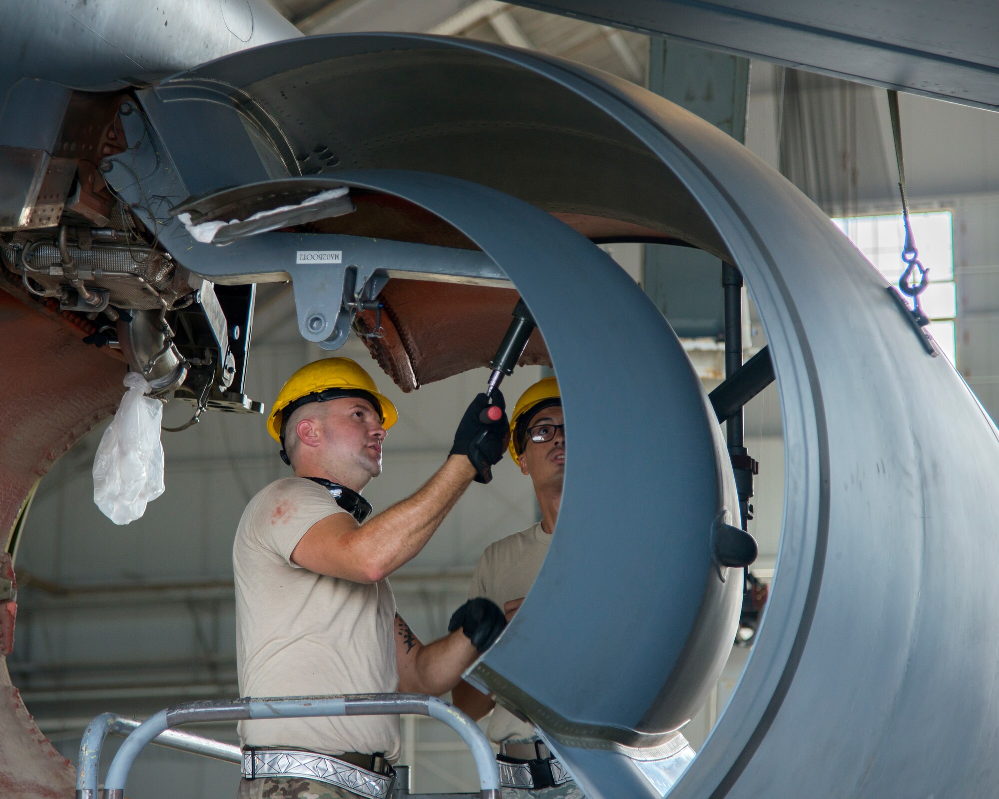 U.S. Air Force Tech Sgt. Eric Holton, a 6th Maintenance Squadron (MXS) aerospace propulsion NCO in charge, and Staff Sgt. Neftali Torres Cruz, a 6th MXS crew chief, inspect the cowling of a KC-135 Stratotanker, July 1, 2019, at MacDill Air Force Base, Fla.