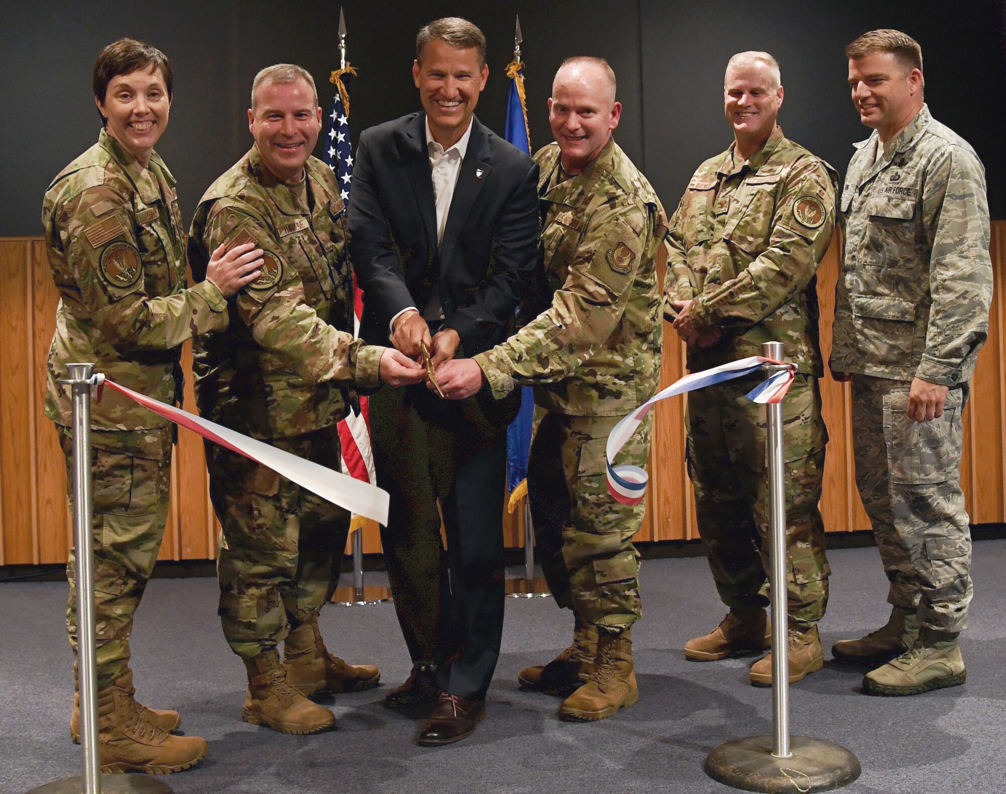 From left to right; Col. Brenda Oppel, incoming director of the Enterprise IT as-a-Service Functional Management Office, Hanscom Air Force Base, Mass; Col. Chad Raduege, Air Combat Command director of Cyberspace and Information Dominance; William Marion, Air Force deputy chief information officer; Maj. Gen. Michael Schmidt, program executive officer for Command, Control, Communications, Intelligence and Networks; Col. William Waynick, outgoing EITaaS FMO director and Col. Bobby King, senior materiel leader for the C3I&N Infrastructure Division, officially activate the EITaaS FMO at Hanscom with a ribbon-cutting ceremony July 9. The new office will unite acquisition managers at Hanscom with ACC and communication users to support EITaaS efforts. (U.S. Air Force photo by Linda LaBonte Britt)