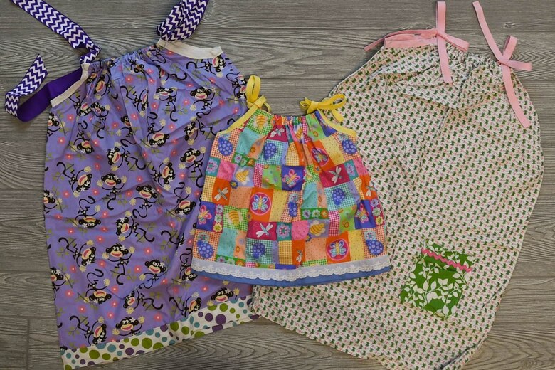 Master Sgt. (Ret.) Keena Alston, 916th Air Refueling Wing commander’s secretary, works fabric through a sewing machine on July 12, 2019. Alston makes dresses that are delivered to vulnerable children all around the world by missionary volunteers. (US Air Force Photo by Jeramy Moore)