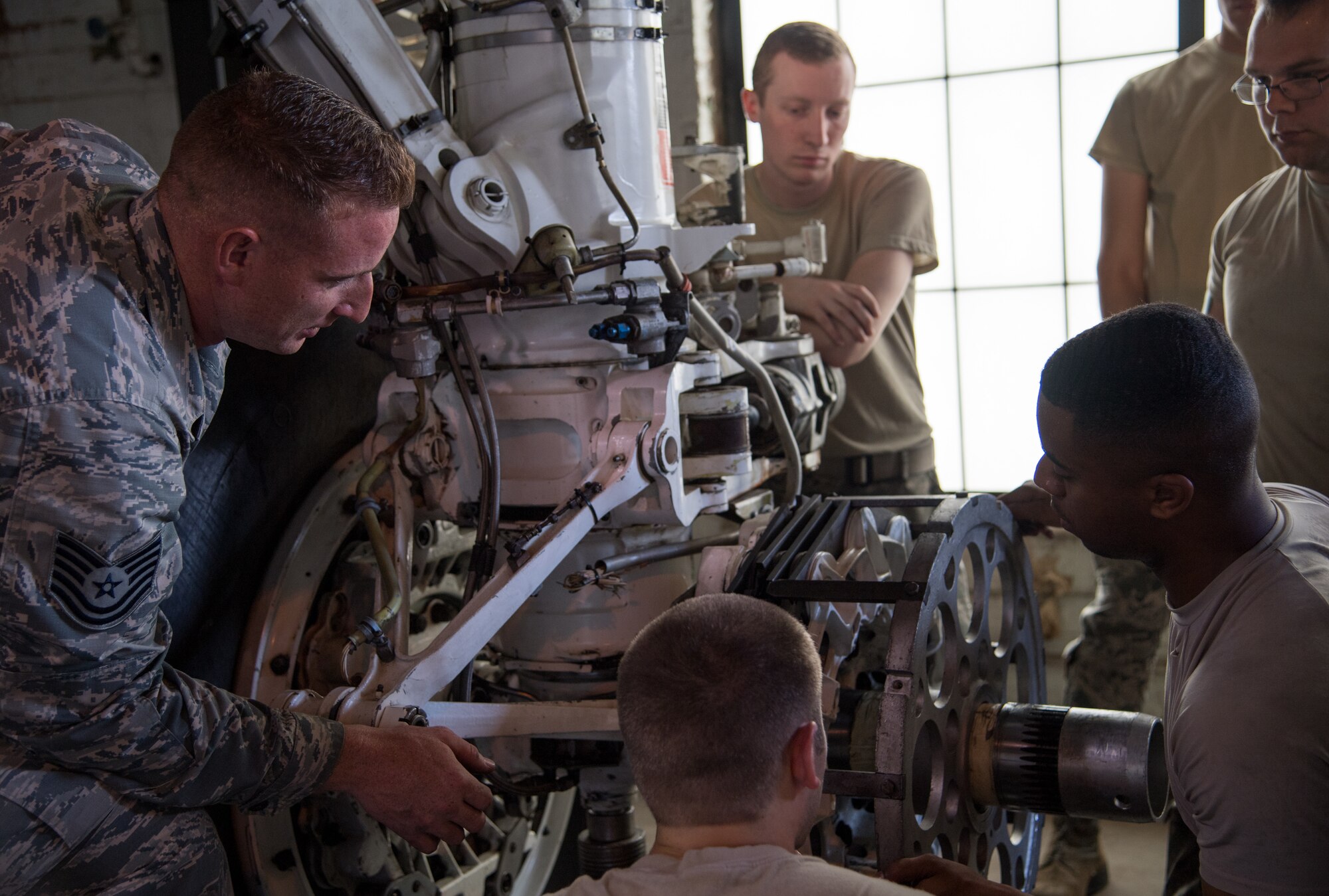 Tech. Sgt. Dylan Drake (left), 372nd Training Squadron Field Training Detachment 5 crew chief instructor, speaks to his students during a course at Barksdale Air Force Base, Louisiana, June 4, 2019. After maintainers graduate Basic Military Training they arrive at their technical school to learn the fundamental parts of their jobs. Once they receive their base assignment they then are trained at an FTD, like Barksdale’s, to learn specifics for their aircraft. (U.S. Air Force photo by Senior Airman Tessa B. Corrick