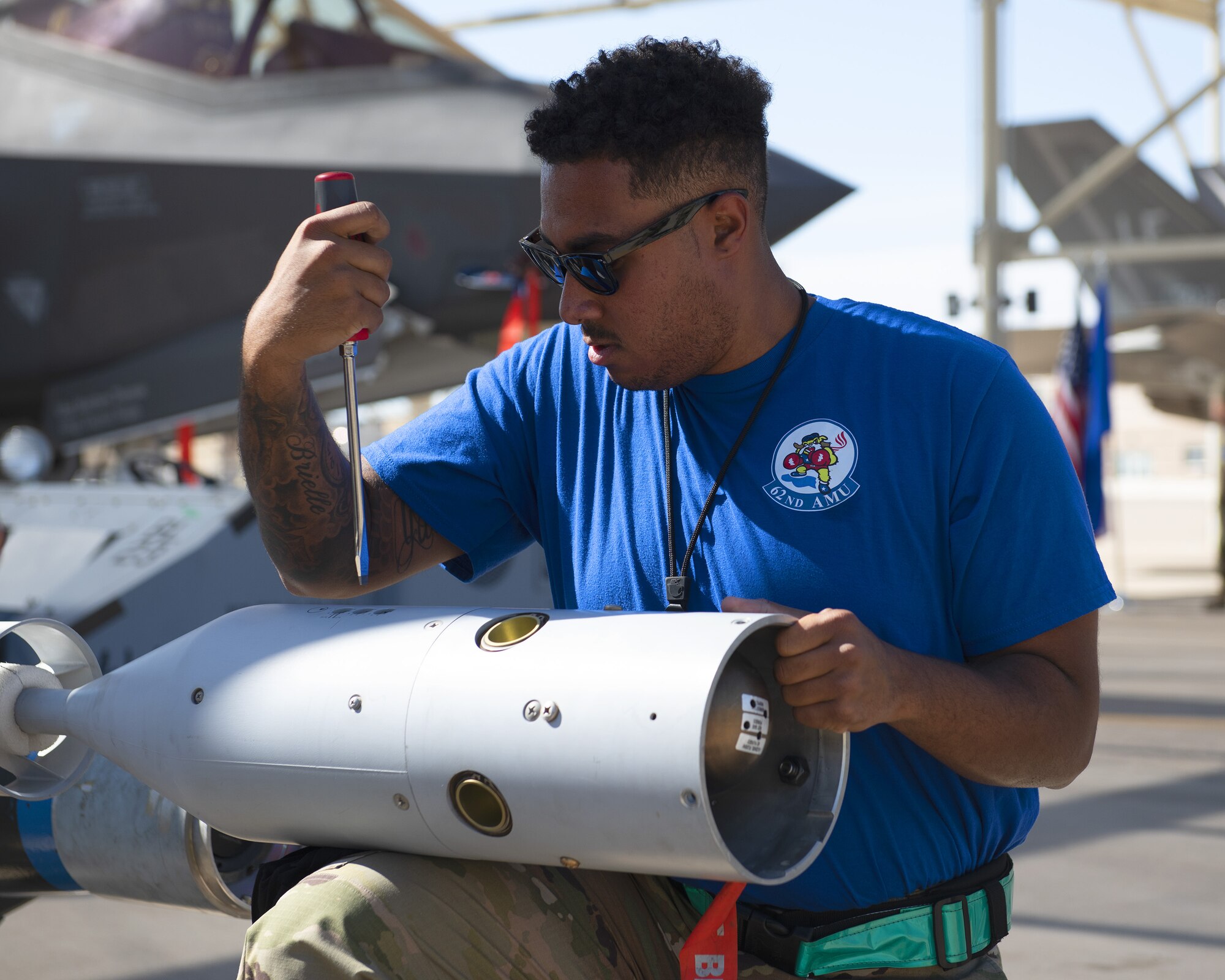 Staff Sgt. Jeromie Gathers, 62nd Aircraft Maintenance Unit load crew member, makes adjustments to an inert bomb July 18, 2019, at Luke Air Force Base, Ariz.