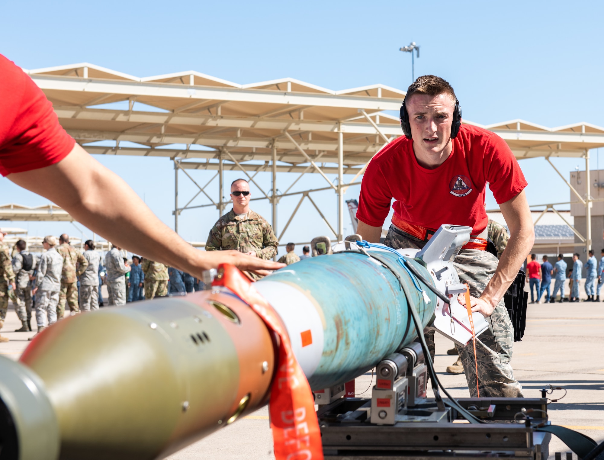 Airman 1st Class Calvin Henderson, 62nd Aircraft Maintenance Unit weapons load crew member, works with his team to prepare an inert bomb to be loaded onto an F-35A Lighting II July 18, 2019, at Luke Air Force Base, Ariz.
