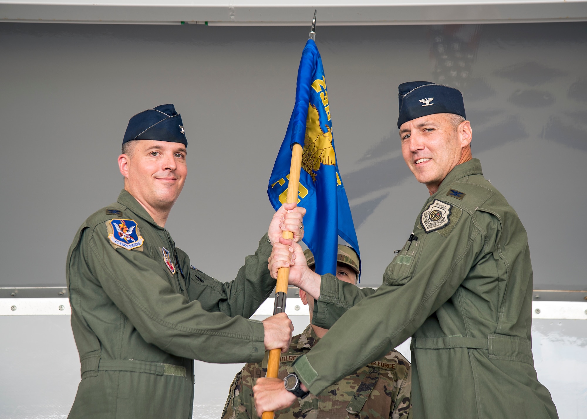 Col. Daniel Walls, left, 23d Wing commander, presents the guidon to Col. Ryan Haden, right, 23d Fighter Group (FG) commander,  as he assumes command during the 23d FG change of command ceremony, July 19, 2019, at Moody Air Force Base, Ga. The 23d FG is the Air Force’s largest A-10C Thunderbolt II fighter group that consists of two combat ready A-10C squadrons and an operation support squadron.  Haden previously served as the J5/8 plans division, Eastern Flank Branch Chief, United States European Command, Germany. Haden is no stranger to the 23d FG as he previously commanded the 74th Fighter Squadron and served as deputy commander for the 23d FG. (U.S. Air Force photo by Airman 1st Class Eugene Oliver)