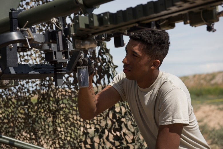 U.S. Air Force Airman 1st Class Miles Swammi, 726th ACS radar systems technician, affixes a filter onto a Ground Mulitband Terminal (GMT) during a 726th Air Control Squadron Hardrock Exercise 19-2 July 16th, 2019, at Mountain Home Air Force Base, Idaho. The filter helps to soak water from the internel gear of the GMT. (U.S. Air Force photo by Senior Airman Tyrell Hall)