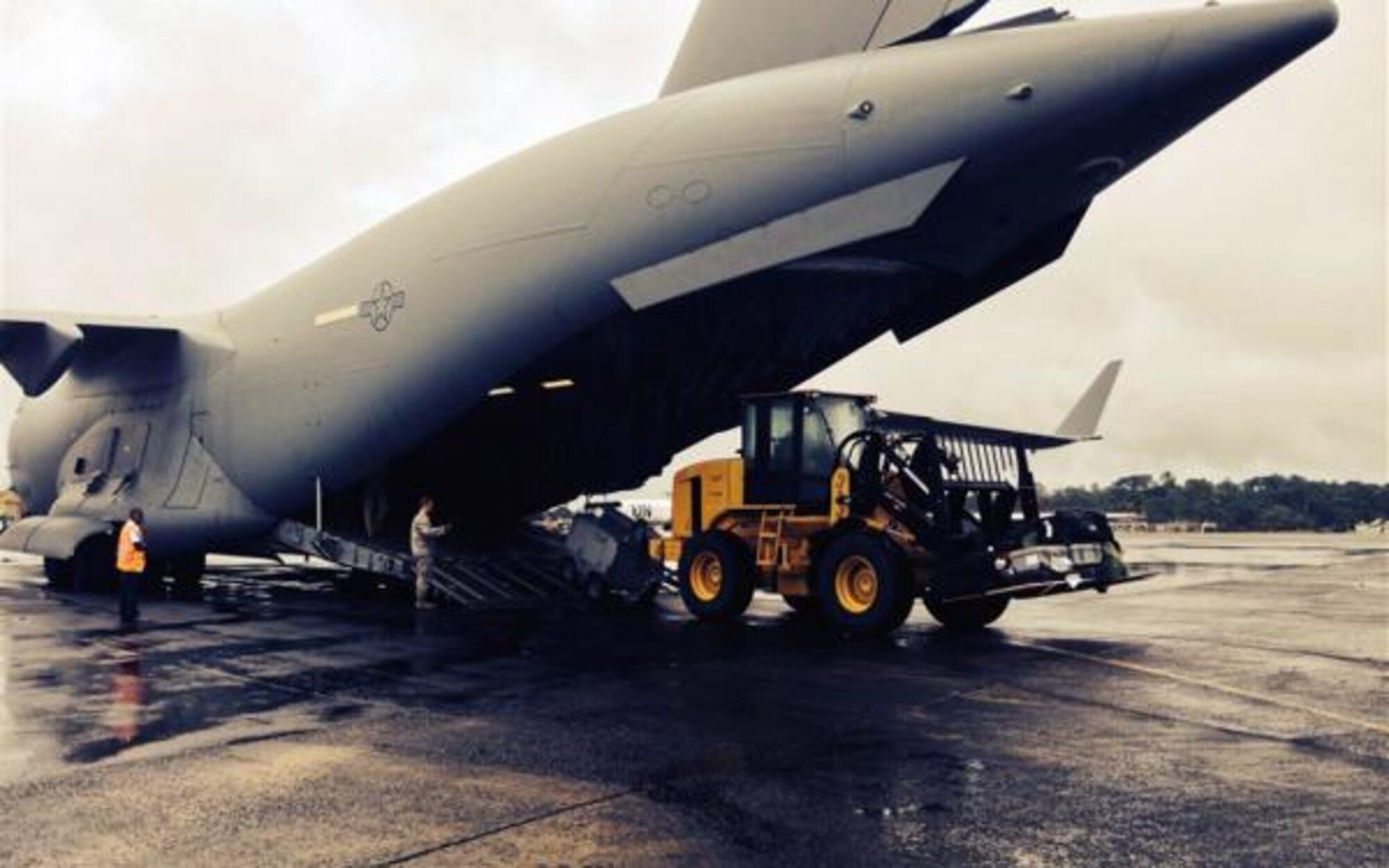 Team McChord Airmen unload a C-17 Globemaster III in Liberia, October 8, 2014. The Airmen assisted during an ebola outbreak in West Africa.