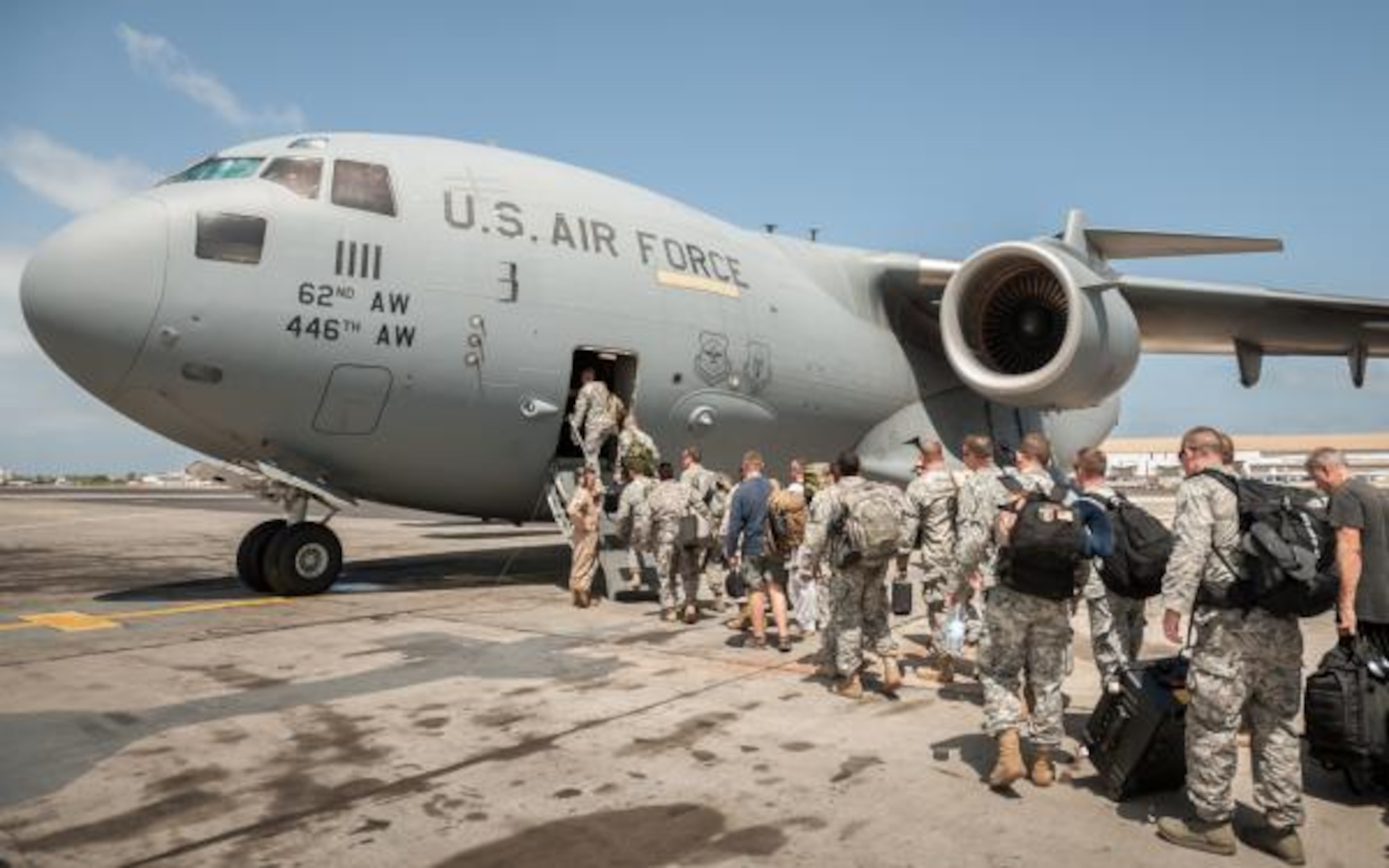 Marines, Airmen and soldiers board a C-17 Globemaster III at Leopold Sedar Senghor International Airport, Senegal, on October 19, 2014, bound for Monrovia, Liberia.