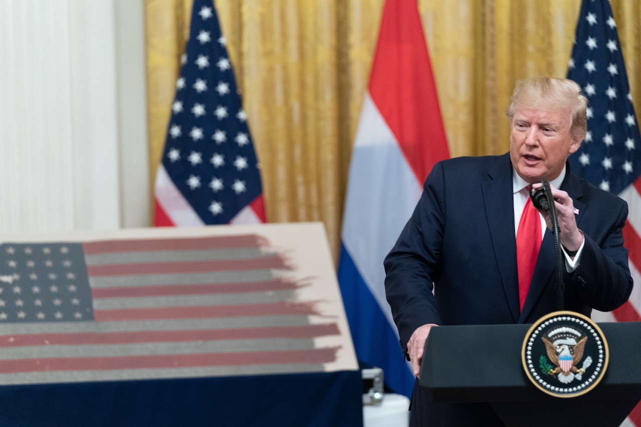 President Trump receives American flag.