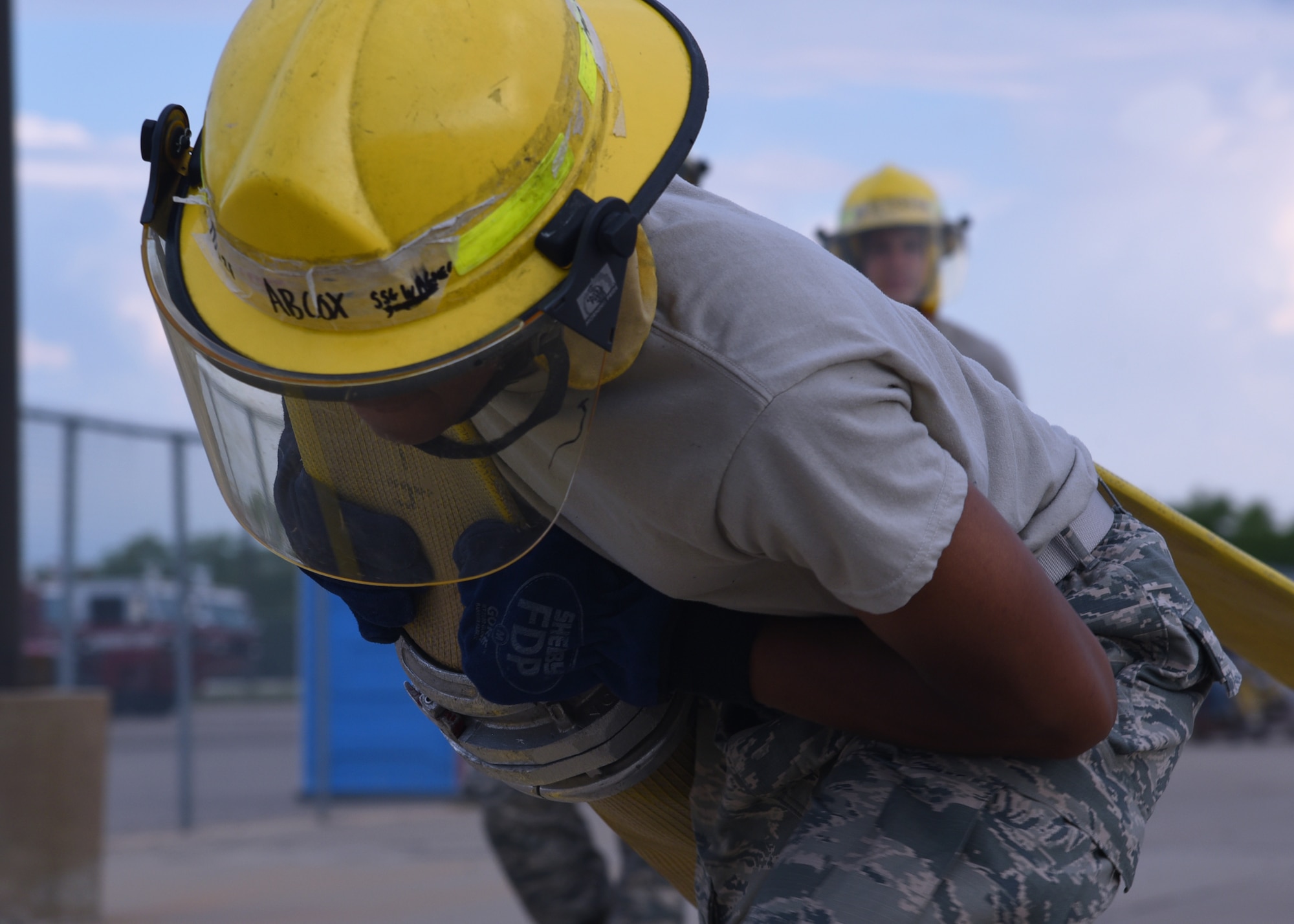 U.S. Air Force Airman Keundra Cox, 312th Training Squadron student, heaves a fire hose out of a fire truck and sprints it to a marked location outside the Louis F. Garland Department of Defense Fire Academy on Goodfellow Air Force Base, Texas, July 11, 2019. Cox and his classmates took turns running the fire hose, learning the strength, endurance and momentum needed to get the hose 100 yards, much like they will outside of the technical training environment. (U.S. Air Force Photo by Airman 1st Class Abbey Rieves/Released)