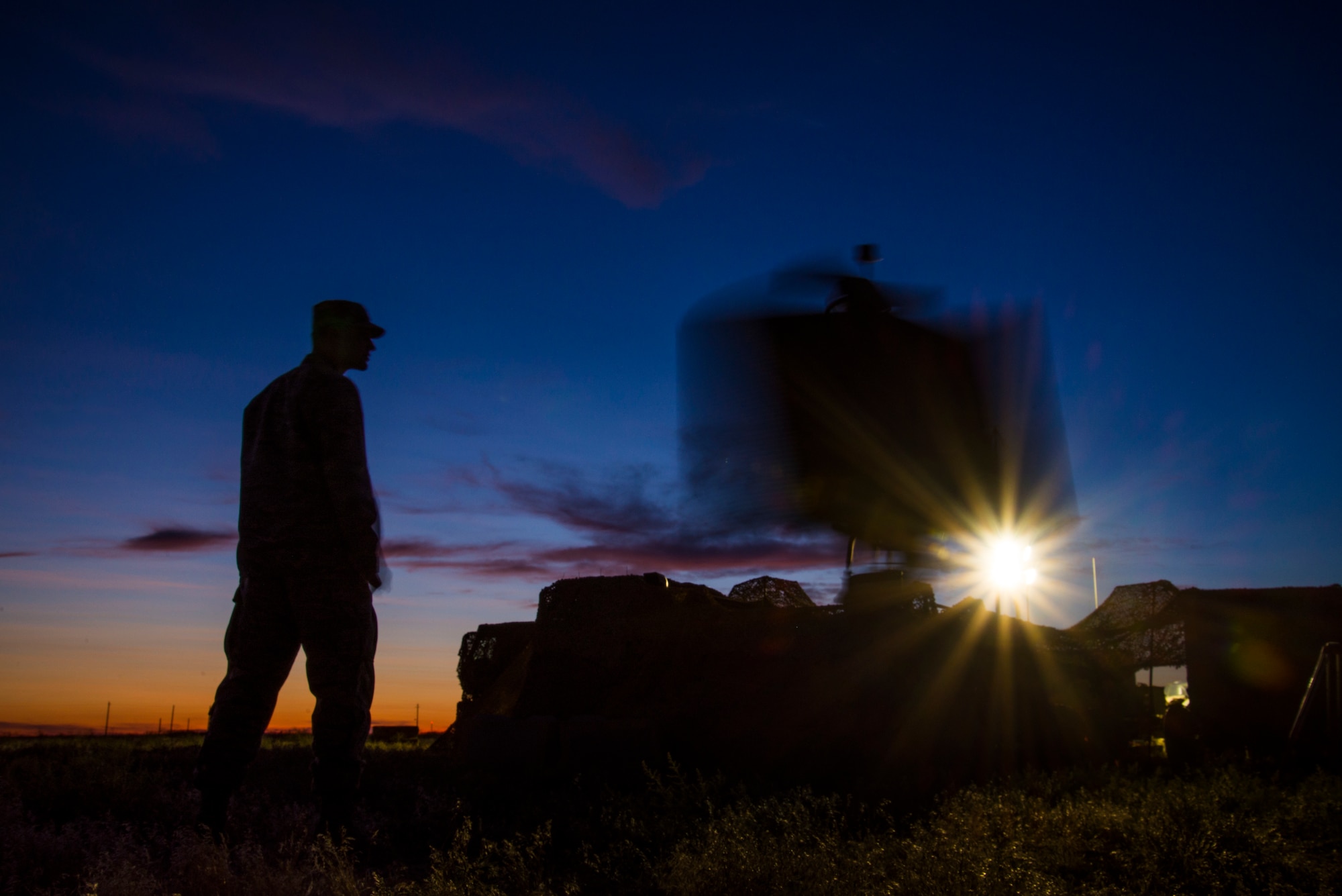 A U.S. Air Force Airman stands next to a TPS-75 radar system while it scans the skies during Hardrock Exercise 19-2, July 16, 2019, at Mountain Home Air Base, Idaho. The exercise was in a simulated deployed location where the base was built from the ground up and took control of the airspace. (U.S. Air Force photo by Airman 1st Class Andrew Kobialka)