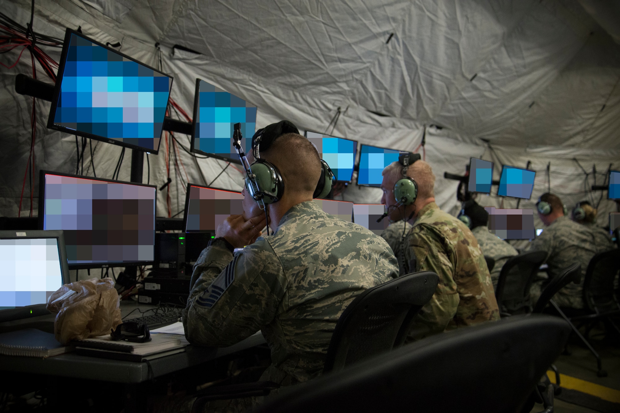 U.S. Air Force Airmen from the 726th Air Control Squadron control the airspace from inside a tactical operations center during Hardrock Exercise 19-2, July 17, 2019, at Mountain Home Air Base, Idaho. The exercise was in a simulated deployed location where the base was built from the ground up and took control of the airspace. The monitors were blurred as a security precaution. (U.S. Air Force photo by Airman 1st Class Andrew Kobialka)