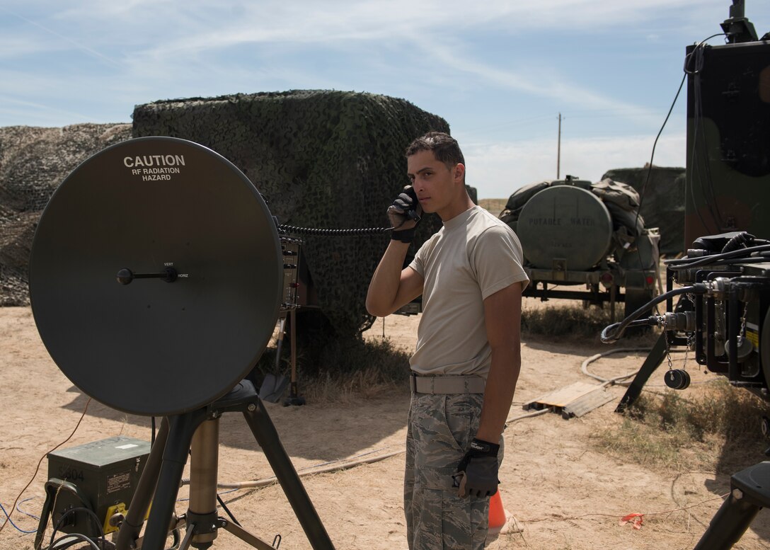 U.S. Air Force Airman 1st Class Giovanni Gonzalez, 726th Air Control Squadron, radar systems technician, uses a Tropo Satellite Suport Radio during the 726th ACS Hardrock Exercise 19-2, July 16, 2019, at Mountain Home Air Force Base, Idaho. The 726th ACS play a vital role in communication capabilities between personnel. (U.S. Air Force photo by Senior Airman Tyrell Hall)