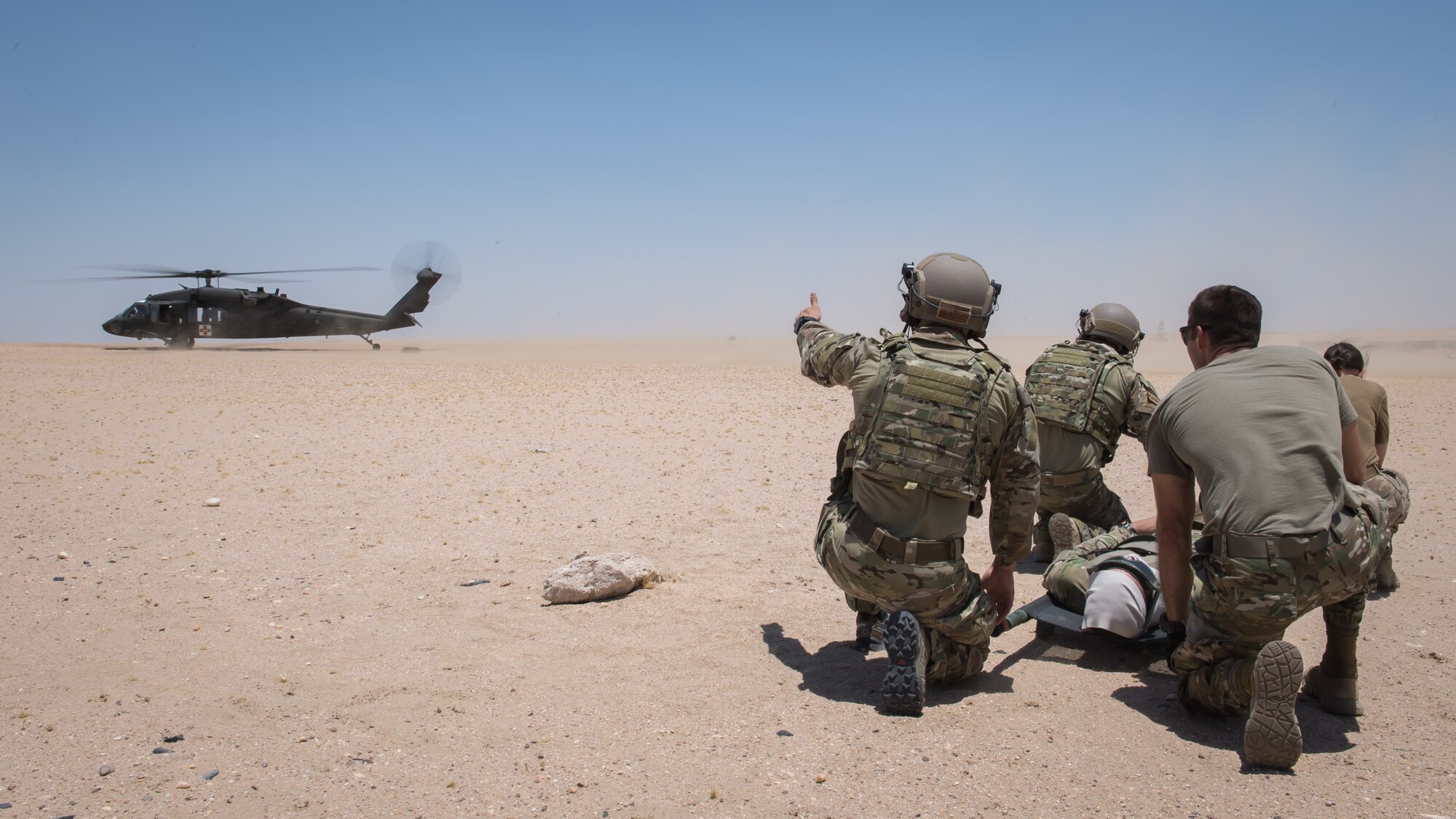 Airmen from the 386th Expeditionary Medical Group based at Ali Al Salem Air Base, Kuwait, and Tactical Air Control Party Airmen with the 82nd Expeditionary Air Support Operations Squadron, prepare to transport a patient onto a UH-60 Blackhawk helicopter during medical evacuation training at Camp Buehring, Kuwait, July 12, 2019. Medics and TACP’s trained together to hone their skills and become more efficient at treating injuries and coordinating medevac efforts for casualties. (U.S. Air Force photo by Tech. Sgt. Daniel Martinez)