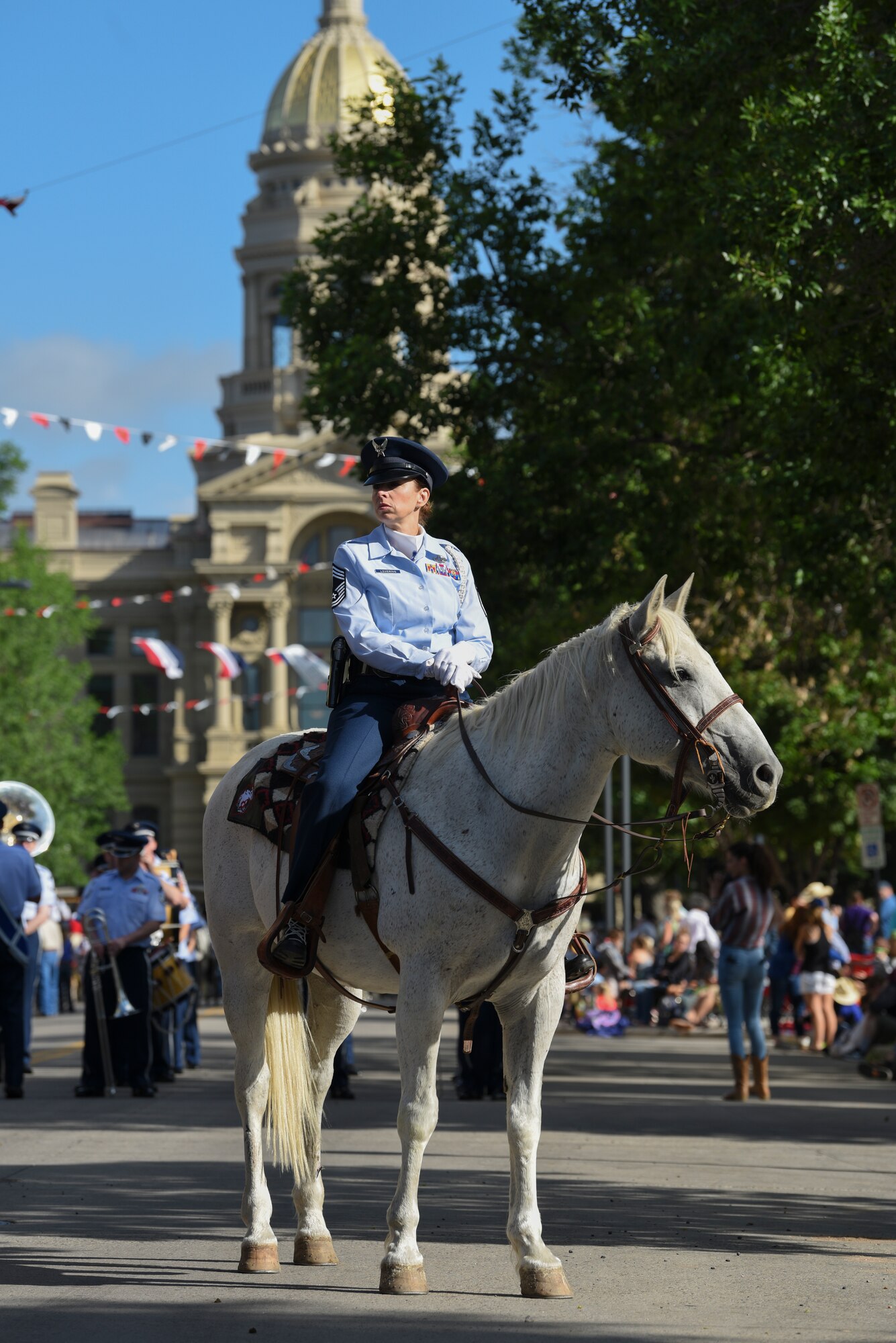Chief MSgt. Jennifer Lovering, 153rd Communications Flight operations superintendent, rides her horse at the capitol building during the Grand Parade, July 20, 2019. This year marks the 152nd anniversary of F.E. Warren Air Force Base and the city of Cheyenne. The F.E. Warren Air Force Base and Cheyenne communities came together to celebrate the CFD rodeo and festival, which runs from July 19-28. (U.S. Air Force photo by Staff Sgt. Ashley N. Sokolov)