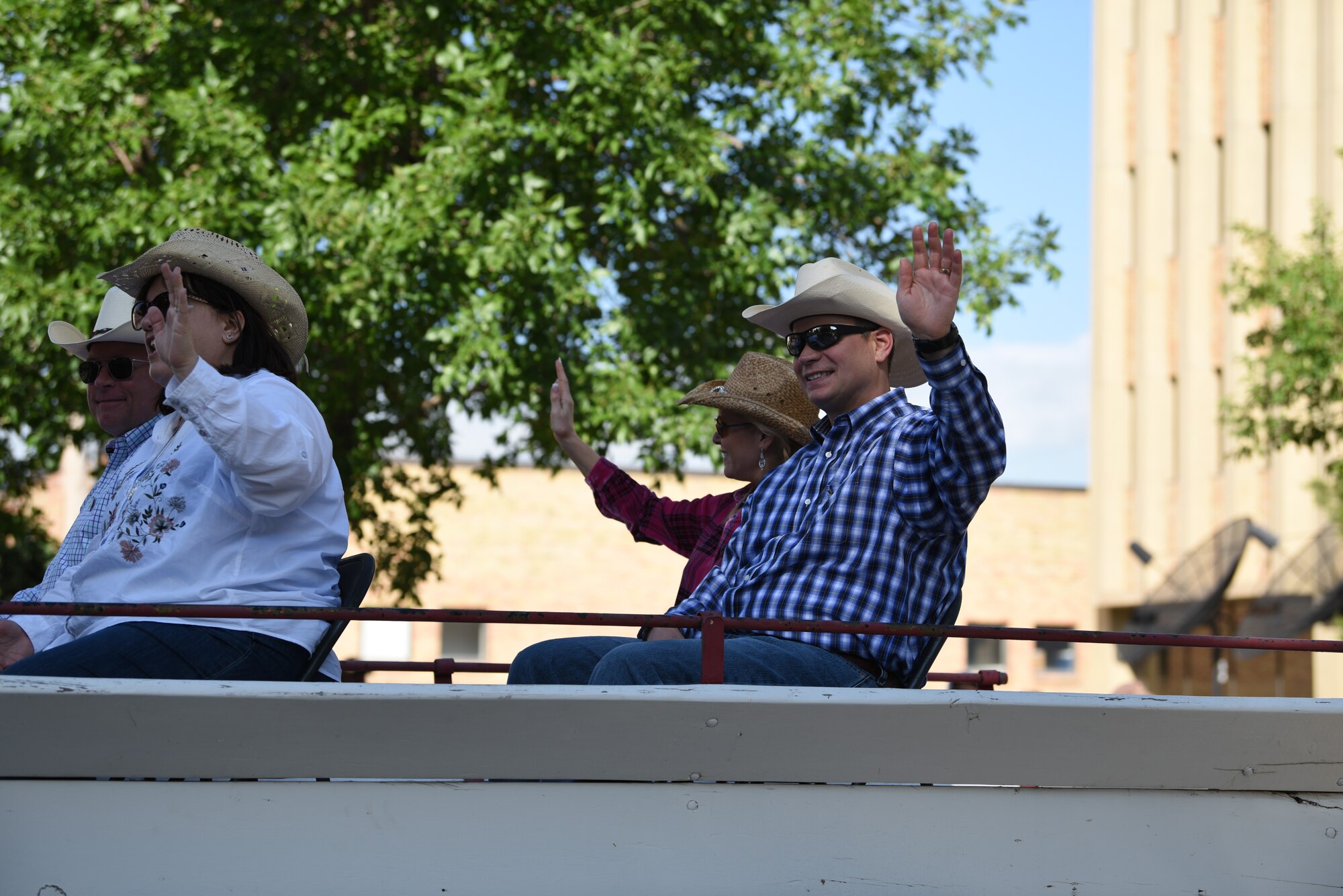 Major General Fred Stoss, 20th Air Force commander, and Col. Peter Bonetti, 90th Missile Wing commander, along with their famillies, wave at the crowd during the 123rd Cheyenne Frontier Days opening Grand Parade in Cheyenne, Wyo., July 20, 2019. The Cheyenne community and F.E. Warren Air Force Base have been working together for 123 years to keep the Daddy of ‘em All, running smoothly. (U.S. Air Force photo by Staff Sgt. Ashley N. Sokolov)