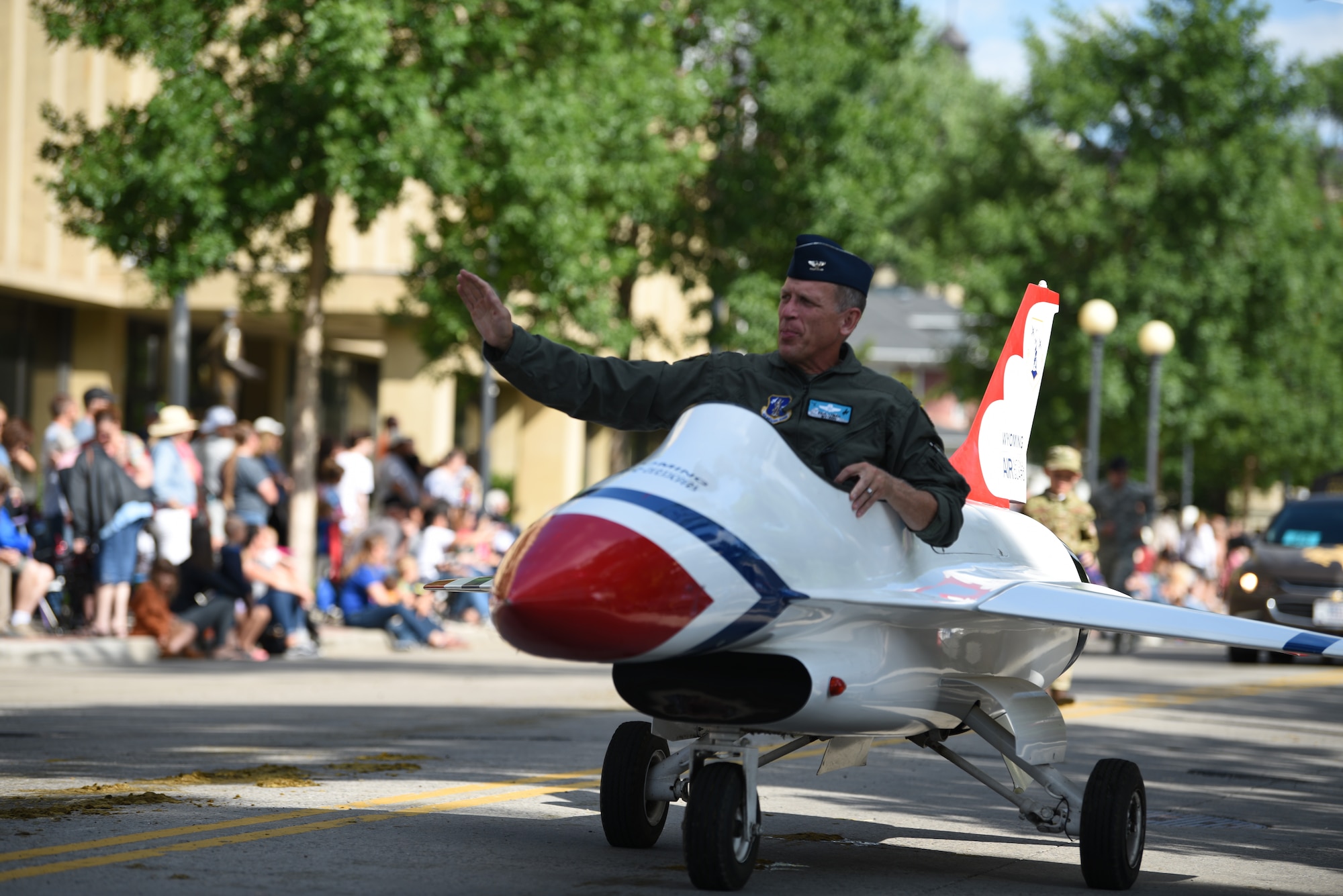 Col. Paul Lyman, Assistant Adjutant General, Wyoming National Guard, waves at the crowd while driving a miniature motorized vehicle during the 123rd Cheyenne Frontier Days opening Grand Parade in Cheyenne, Wyo., July 20, 2019. Service members from multiple branches took part in the parade. This year marks the 152nd anniversary of F.E. Warren Air Force Base and the city of Cheyenne. The F.E. Warren Air Force Base and Cheyenne communities came together to celebrate the CFD rodeo and festival, which runs from July 19-28. (U.S. Air Force photo by Staff Sgt. Ashley N. Sokolov)
