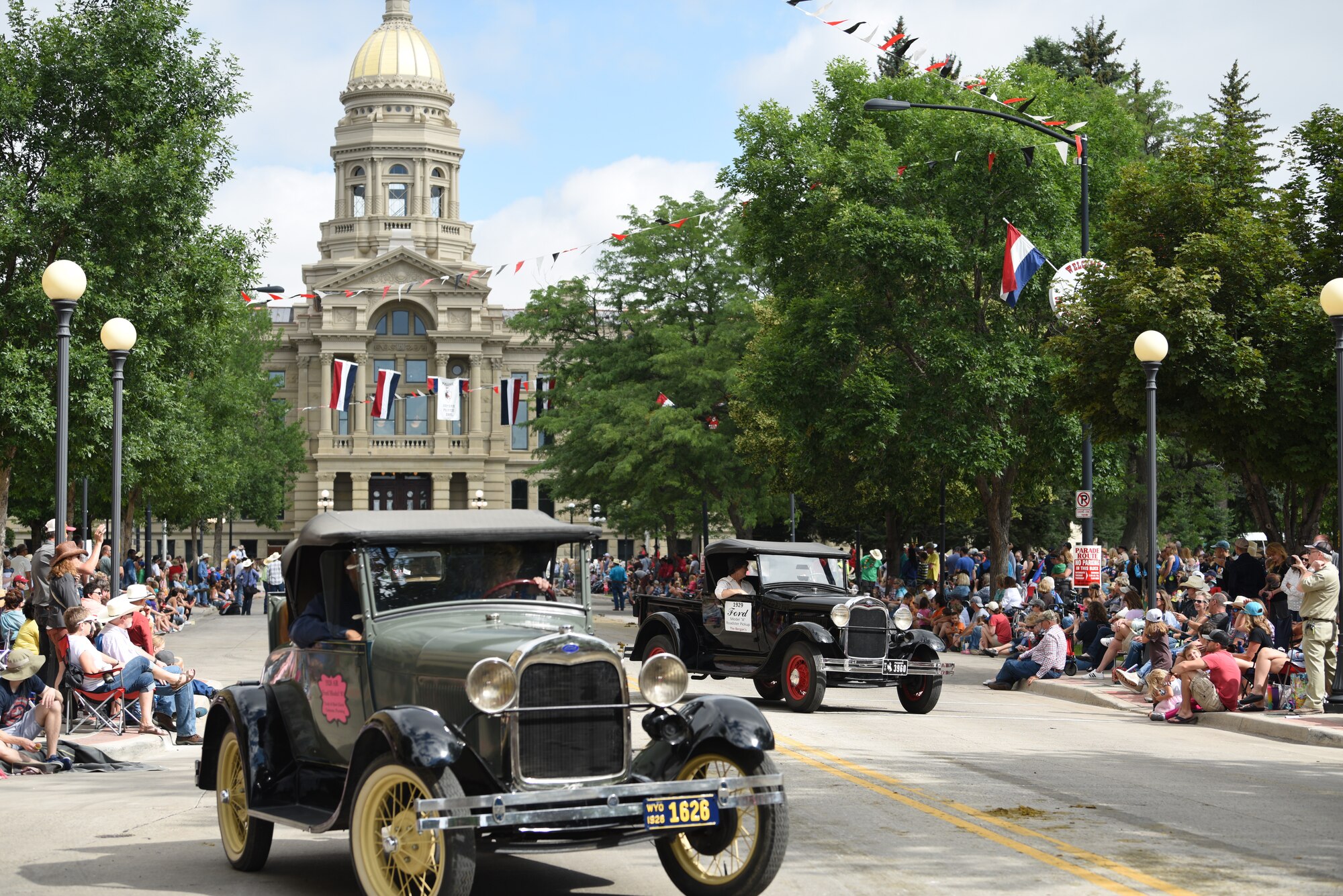 Parade participants drive historic cars during the Grand Parade in Cheyenne, Wyo., July 20, 2019. The Cheyenne community and F.E. Warren Air Force Base have been working together for 123 years to keep the Daddy of ‘em all running smoothly. (U.S. Air Force photo by Staff Sgt. Ashley N. Sokolov)