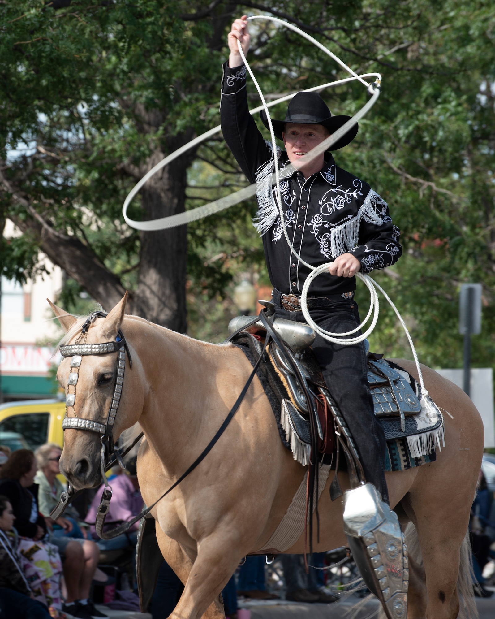 A cowboy roper performs lasso tricks during the Grand Parade in Cheyenne, Wyo., July 20, 2019. The F.E. Warren Air Force Base and Cheyenne communities came together to celebrate the CFD rodeo and festival, which runs from July 19-28. (U.S. Air Force photo by Senior Airman Abbigayle Willams )
