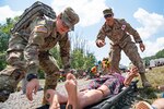 Connecticut Army National Guard Soldiers prepare to transport a mock victim while participating in a Medical Readiness Exercise, July 20, 2019, at the Summit Bechtel Reserve, in Glen Jean, W.Va. Various National Guard and active duty military units, local emergency services, World Scout Jamboree Staff, and Polish Territorial Defense Forces participated in the exercise in preparation for the 24th World Scout Jamboree. (U.S. Air National Guard Photo by Senior Airman Caleb Vance)