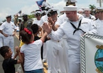 190721-N-AY639-0007 AGANA, Guam (July 21, 2019) Fire Control Technician 2nd Class Patrick Trevino high-fives children during the annual Guam Liberation Day Parade, July 21. The celebration commemorates the 75th anniversary of the liberation of Guam from Japanese occupation by U.S. forces during World War II.