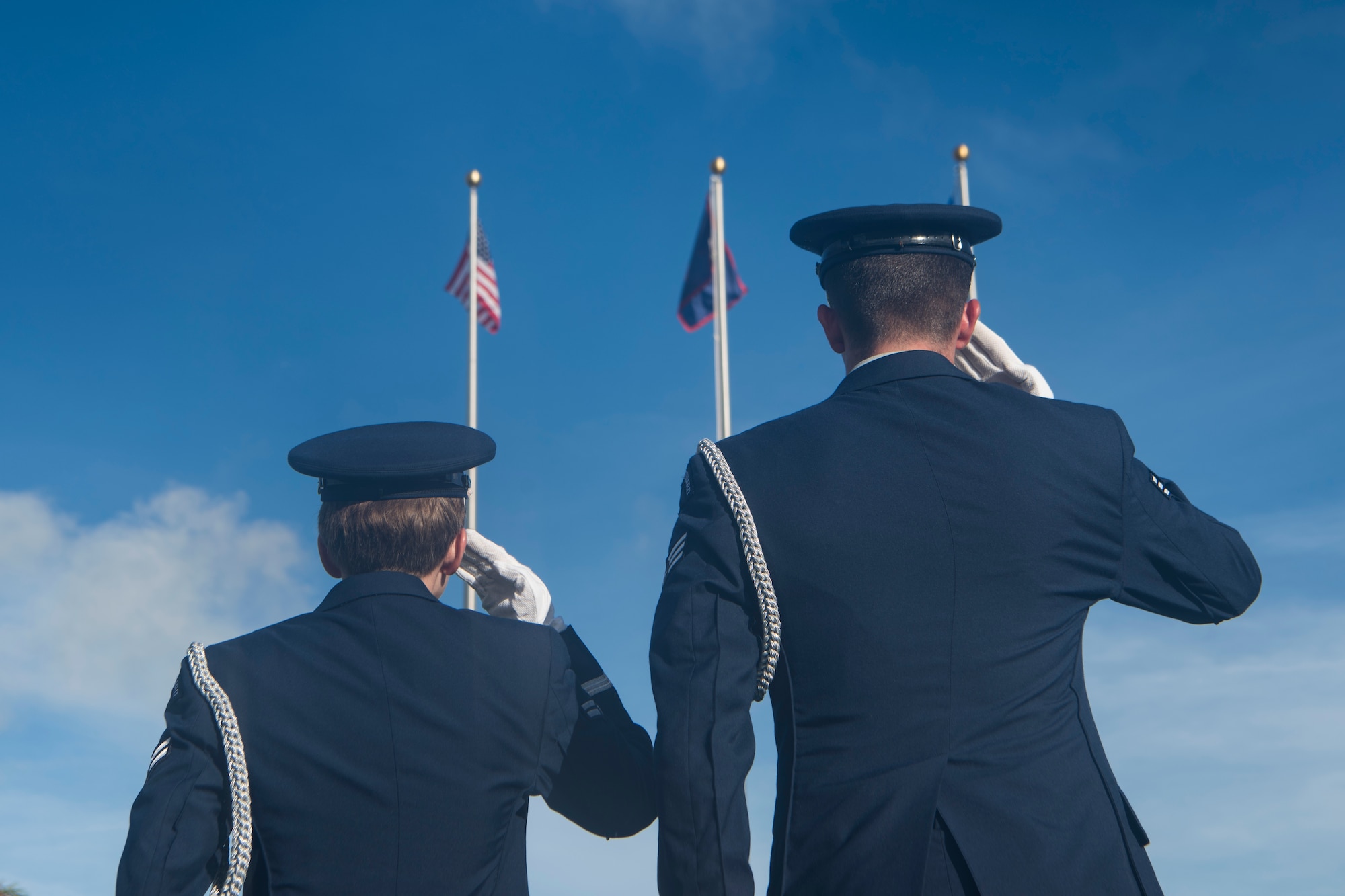 Airmen from the Blue Knights honor guard team salute during the playing of the national anthem during the RAIDR 21 memorial ceremony July 21, 2019 at Andersen Air Force Base, Guam.