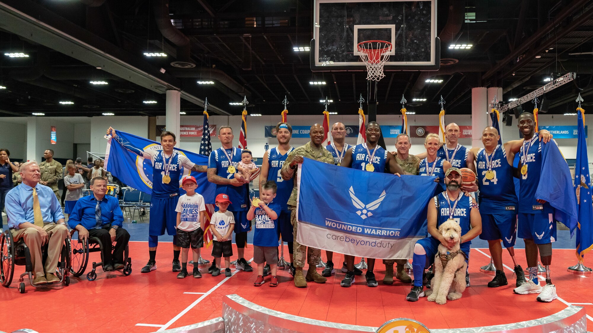 Air Force Chief of Staff Gen. David L. Goldfein and Chief Master Sgt. of the Air Force Kaleth O. Wright pose with the gold medal winner of wheelchair basketball at the 2019 Department of Defense Warrior Games at Tampa, Fla, June 28, 2019. Approximately 300 athletes participated in 13 adaptive sports competitions on June 21-30. (U.S. Air Force photo by Tech Sgt. Lionel Castellano)
