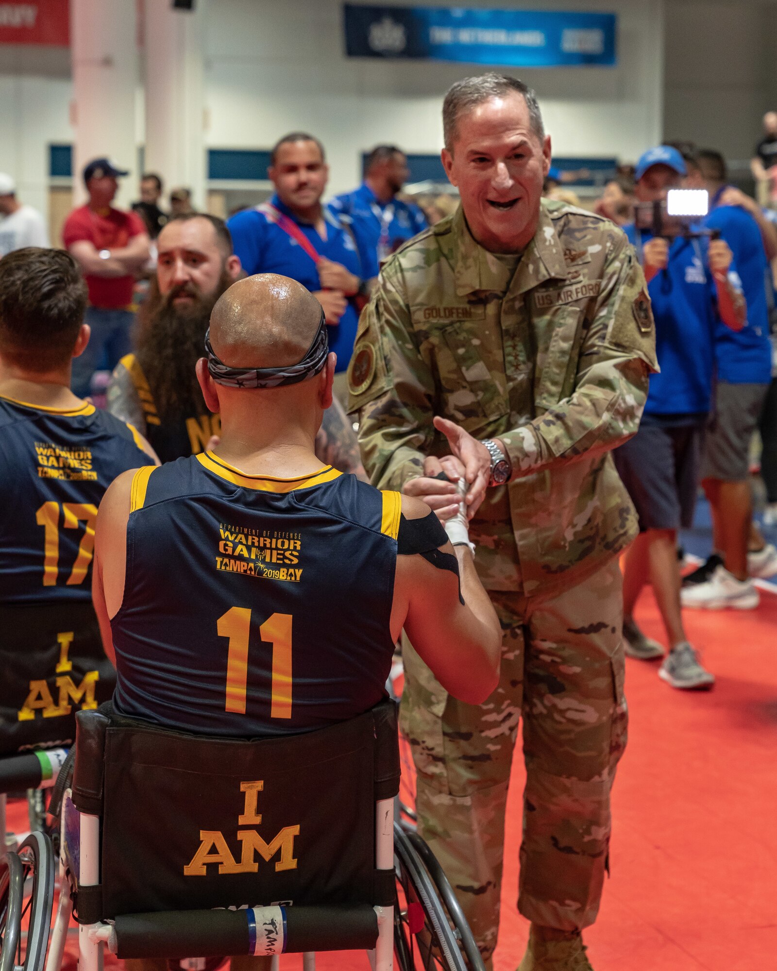 Air Force Chief of Staff Gen. David L. Goldfein congratulates Hospital Corpsman 1st Class Carlos Valerio, a Team Navy athlete, for a well-played game after Team Air Force defeated Team Navy 66-60 in wheelchair basketball at the 2019 Department of Defense Warrior Games at Tampa, Fla, June 28, 2019. The Warrior Games showcase the resilient spirit of today’s service members across all branches of the military. (U.S. Air Force photo by Tech Sgt. Lionel Castellano)