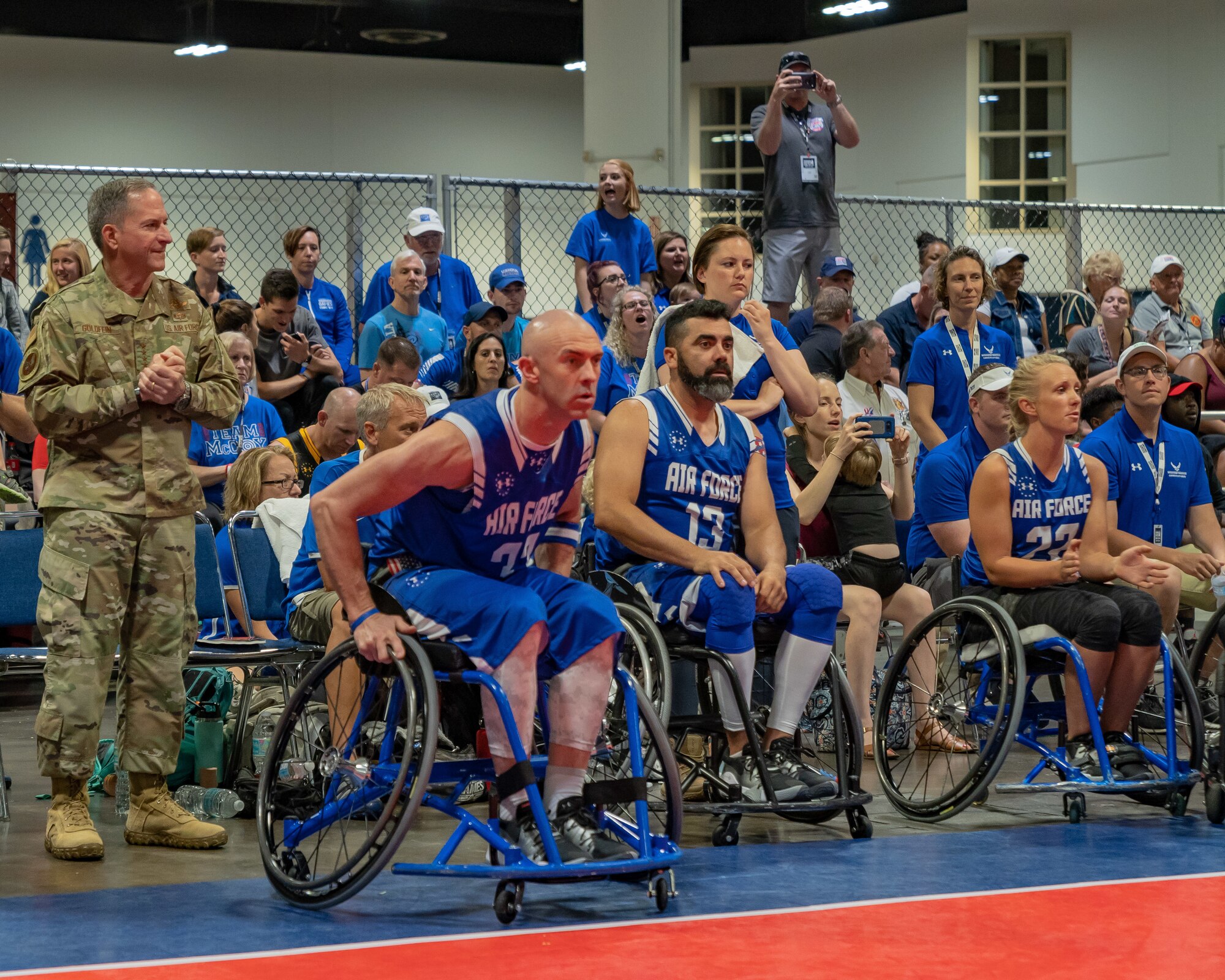 Air Force Chief of Staff Gen. David L. Goldfein and Chief Master Sgt. of the Air Force Kaleth O. Wright cheer on Team Air Force during the wheelchair basketball finals at the 2019 Department of Defense Warrior Games at Tampa, Fla, June 28, 2019. Warrior Games athletes have overcome significant physical and psychological challenges, not always visible to others and have demonstrated that life continues after becoming wounded, ill or injured. (U.S. Air Force photo by Tech Sgt. Lionel Castellano)