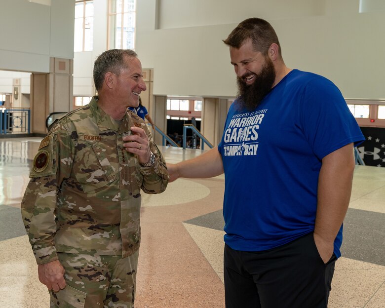 U.S. Air Force Chief of Staff Gen. David L. Goldfein and retired Capt. Lawrence R. Hufford II, Team Air Force athlete, share a joke during the 2019 Department of Defense Warrior Games at Tampa, Fla, June 28, 2019. The DoD Warrior Games were established in 2010 as a way to enhance the recovery and rehabilitation of wounded, ill and injured service members and expose them to adaptive sports. (U.S. Air Force photo by Tech Sgt. Lionel Castellano)