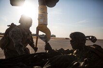 U.S. Marines with Special Purpose Marine Air-Ground Task Force-Crisis Response-Africa 19.2, Marine Forces Europe and Africa, attach cargo to a U.S. Marine Corps MV-22B Osprey during helicopter support team training on Moron Air Base, Spain, July 9, 2019. The exercise was conducted to increase interoperability between the aviation combat element and logistics combat element. SPMAGTF-CR-AF is deployed to conduct crisis-response and theater-security operations in Africa and promote regional stability by conducting military-to-military training exercises throughout Europe and Africa. (U.S. Marine Corps photo by Cpl. Margaret Gale)