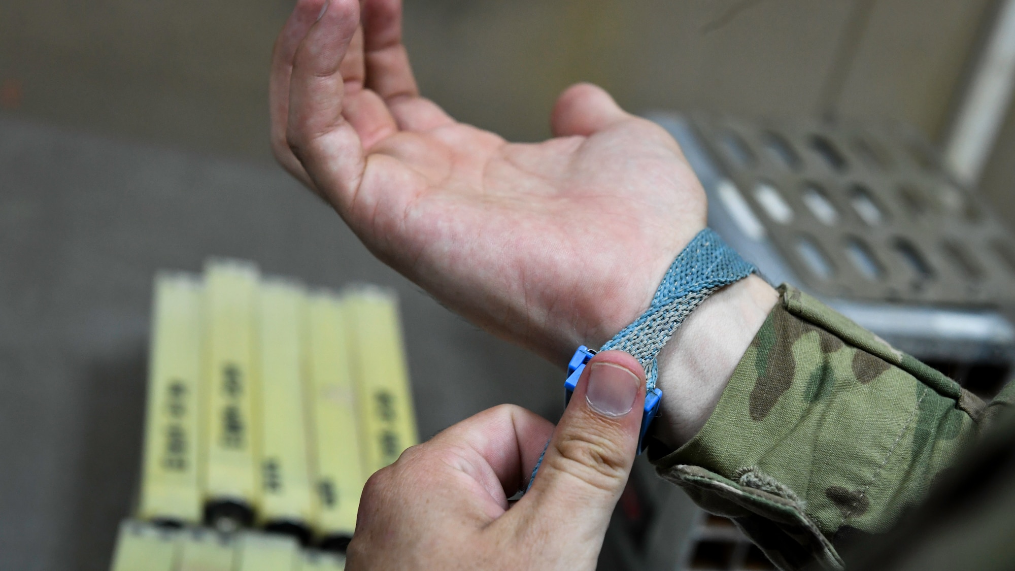 U.S. Air Force Airman 1st Class Conner Quintana, 386th Expeditionary Maintenance Squadron munitions technician journeyman, straps on a static electricity band before working with aircraft flares at Ali Al Salem Air Base, Kuwait, July 18, 2019. Anti-static armbands are used to prevent accidental activation of flares during the maintenance process. (U.S. Air Force photo by Staff. Sgt. Mozer O. Da Cunha)