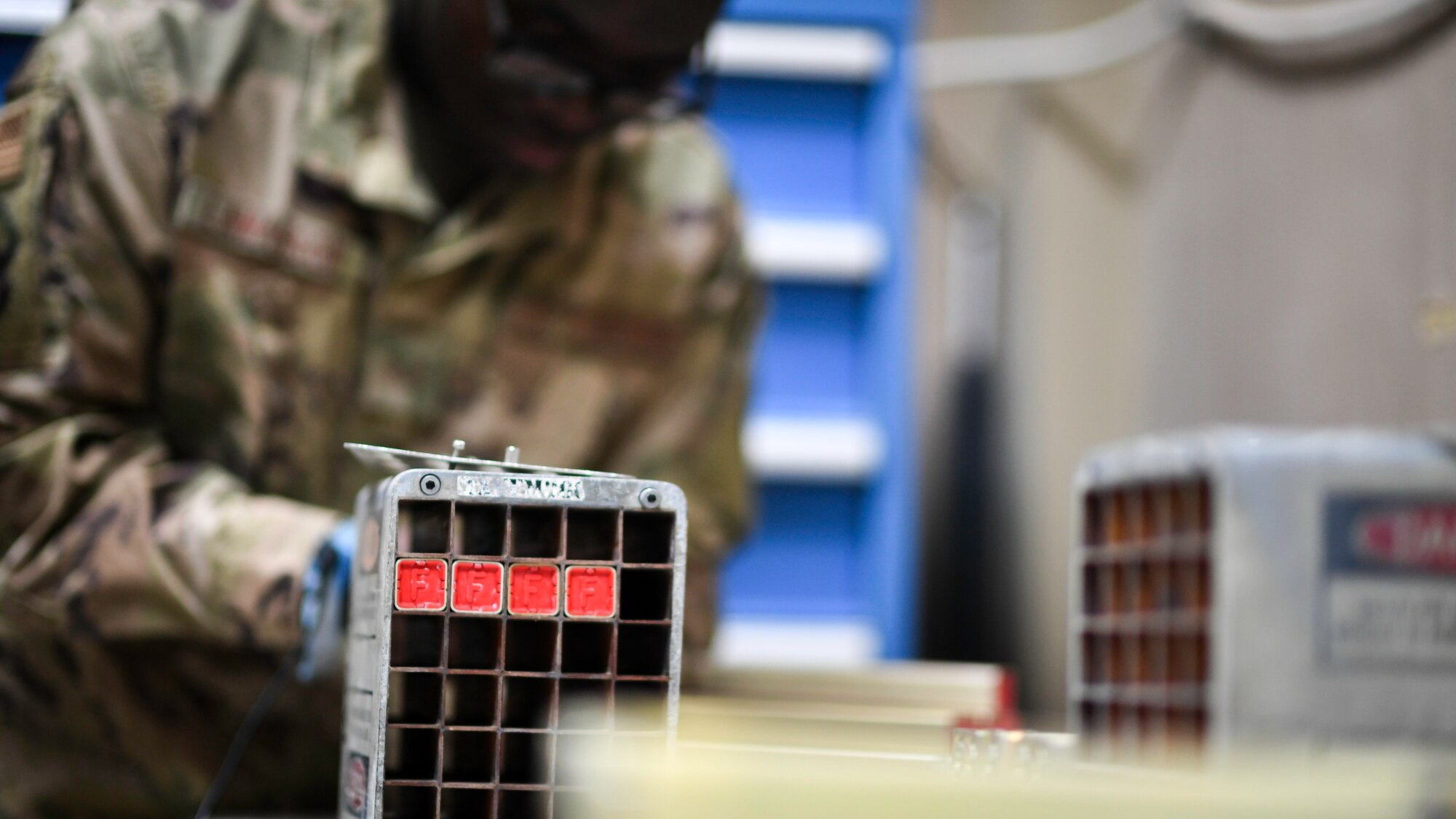 U.S. Air Force Senior Airman Samson Lawanson, 386th Expeditionary Maintenance Squadron munitions technician journeyman, installs flares into a housing module at Ali Al Salem Air Base, Kuwait, July 18, 2019. Housing modules can carry a variety of “cocktails” to include flares, chaff or a mixture of both to be used as munitions or as an electronic countermeasure. (U.S. Air Force photo by Staff. Sgt. Mozer O. Da Cunha)