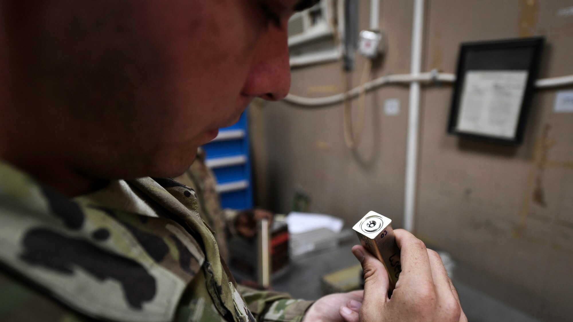 U.S. Air Force Airman 1st Class Conner Quintana, 386th Expeditionary Maintenance Squadron munitions technician journeyman, inspects a flare unit before installing it into a housing module at Ali Al Salem Air Base, Kuwait, July 18, 2019. Flares and chaff are routinely inspected to verify expiration dates, guaranteeing proper functionality in the event countermeasures are needed during operations. (U.S. Air Force photo by Staff. Sgt. Mozer O. Da Cunha)