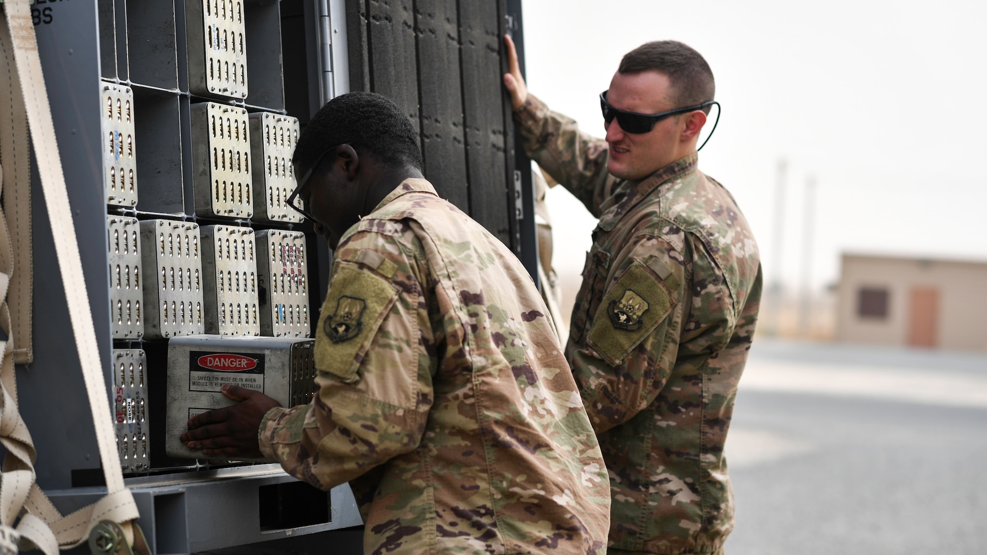 U.S. Air Force Senior Airmen Samson Lawanson and Reid Edmonds, 386th Expeditionary Maintenance Squadron munitions technician journeymen, store a flare housing module into a transportation trailer at Ali Al Salem Air Base, Kuwait, July 18, 2019. Transportation trailers are used to store units after they are inspected and repackaged before delivery to the aircraft. (U.S. Air Force photo by Staff. Sgt. Mozer O. Da Cunha)