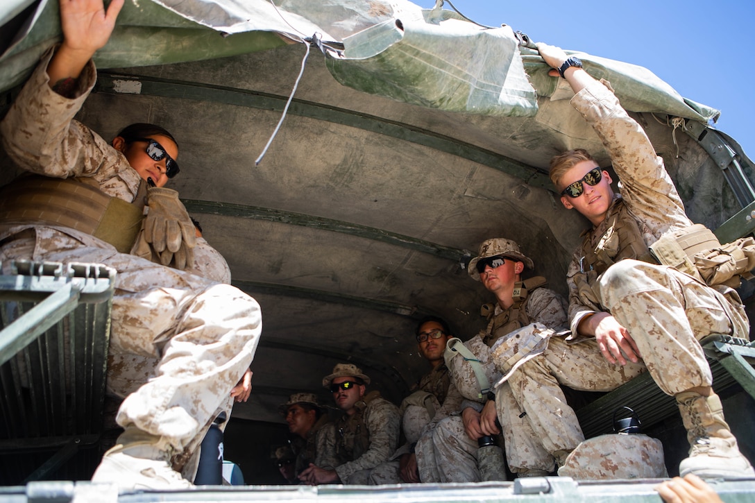 U.S. Marines with Combat Logistics Battalion 2, Combat Logistics Regiment 2, 2nd Marine Logistics Group load into the back of a medium tactical vehicle replacement during integrated training exercise 5-19 on Marine Corps Air Ground Combat Center Twentynine Palms, California, July 17, 2019. The purpose of ITX 5-19 is to create a challenging, realistic training environment that produces combat-ready forces capable of operating as an integrated Marine Air-Ground Task Force. (U.S. Marine Corps photo by Lance Cpl. Scott Jenkins)
