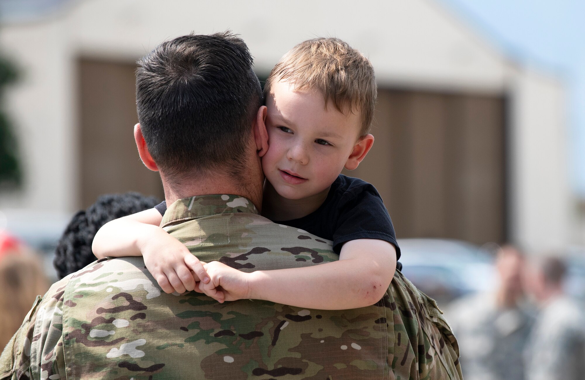 A U.S. Air Force member from the 48th Fighter Wing reunites with his family at Royal Air Force Lakenheath, England, July 12, 2019. Members of the 493rd Fighter Squadron and 748th Aircraft Maintenance Squadron were deployed to an undisclosed location for six months. (U.S. Air Force photo by Senior Airman Malcolm Mayfield)