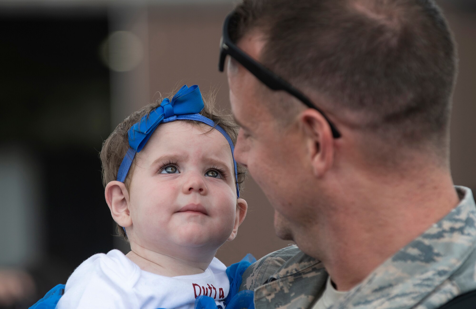 A U.S. Air Force member from the 48th Fighter Wing reunites with his family at Royal Air Force Lakenheath, England, July 12, 2019. Members of the 493rd Fighter Squadron and 748th Aircraft Maintenance Squadron were deployed to an undisclosed location for six months. (U.S. Air Force photo by Senior Airman Malcolm Mayfield)