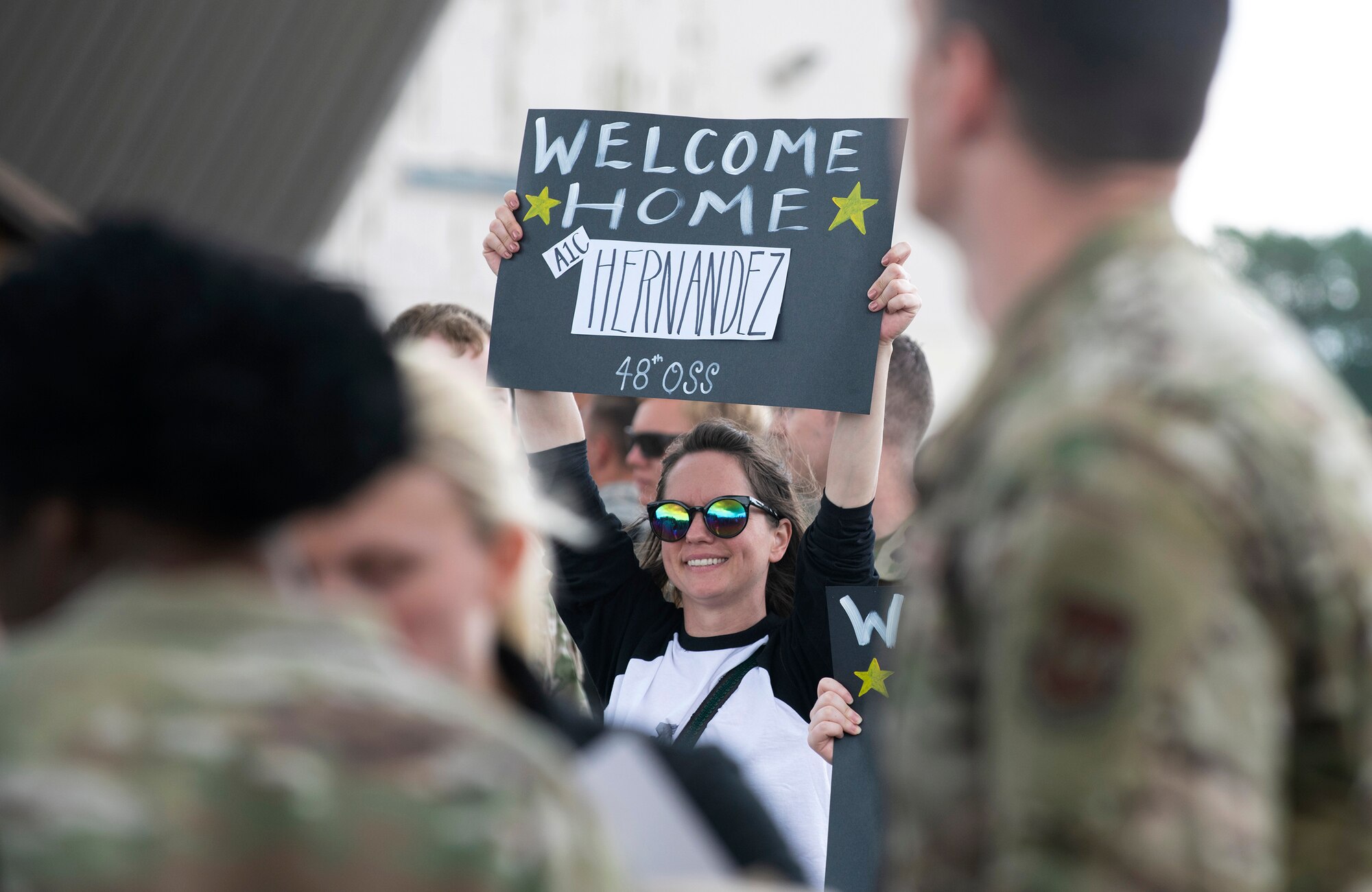 Friends and family members welcome home Airmen from the 48th Fighter Wing at Royal Air Force Lakenheath, England, July 12, 2019. Members of the 493rd Fighter Squadron and 748th Aircraft Maintenance Squadron were deployed to an undisclosed location for six months. (U.S. Air Force photo by Senior Airman Malcolm Mayfield)