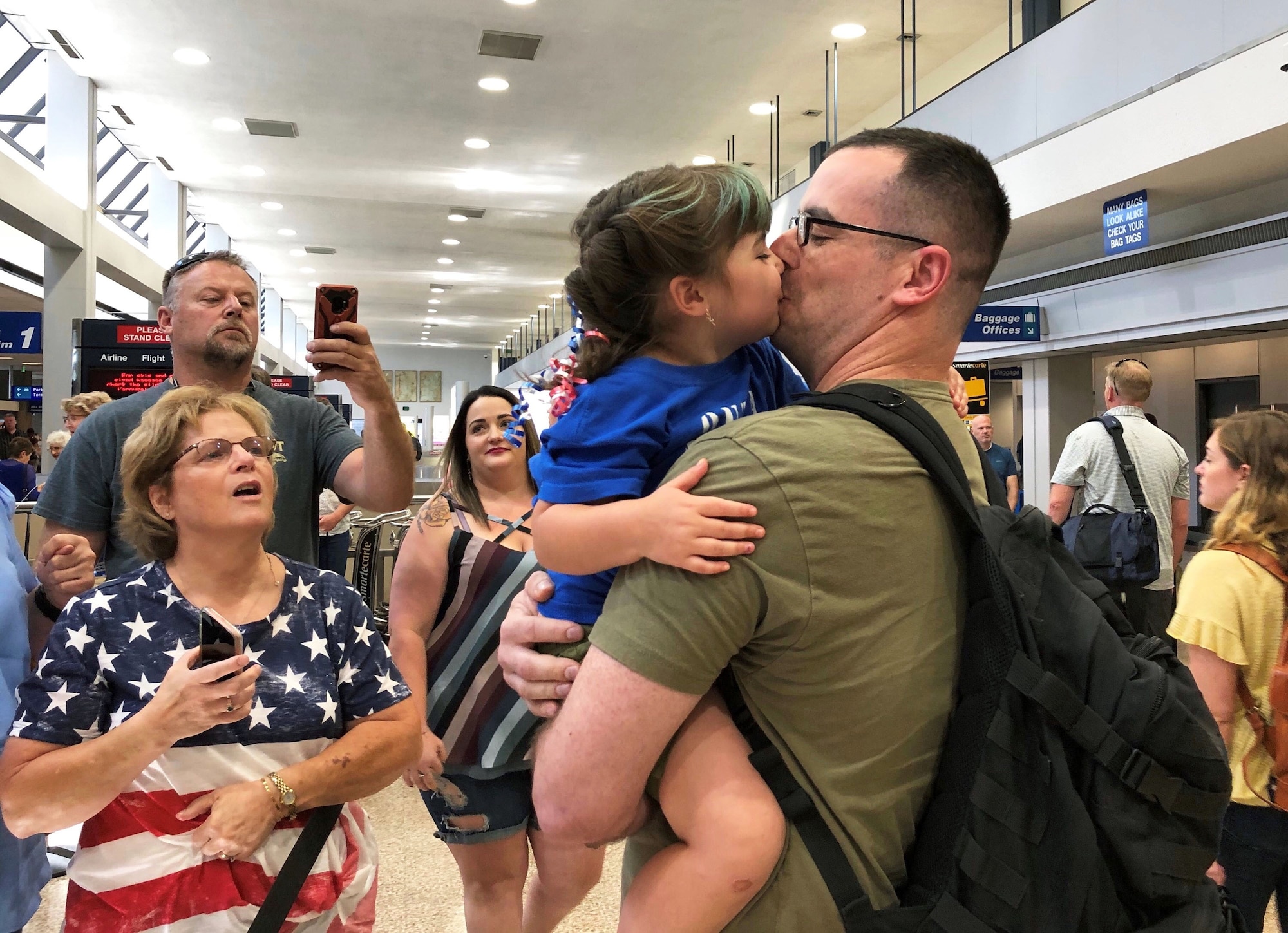 Senior Airman Tyson Kimber from the 419th Maintenance Squadron greets his daughter, Marley, upon returning home July 19 from a three-month deployment to the United Arab Emirates.