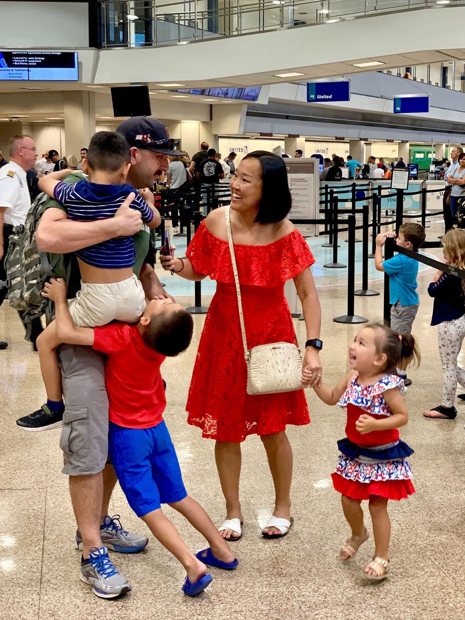 Tech. Sgt. Christopher Korpita, 419th Maintenance Squadron, is met by his wife, Khaliun, and three children after he returned home from a three-month deployment to the United Arab Emirates on July 19.