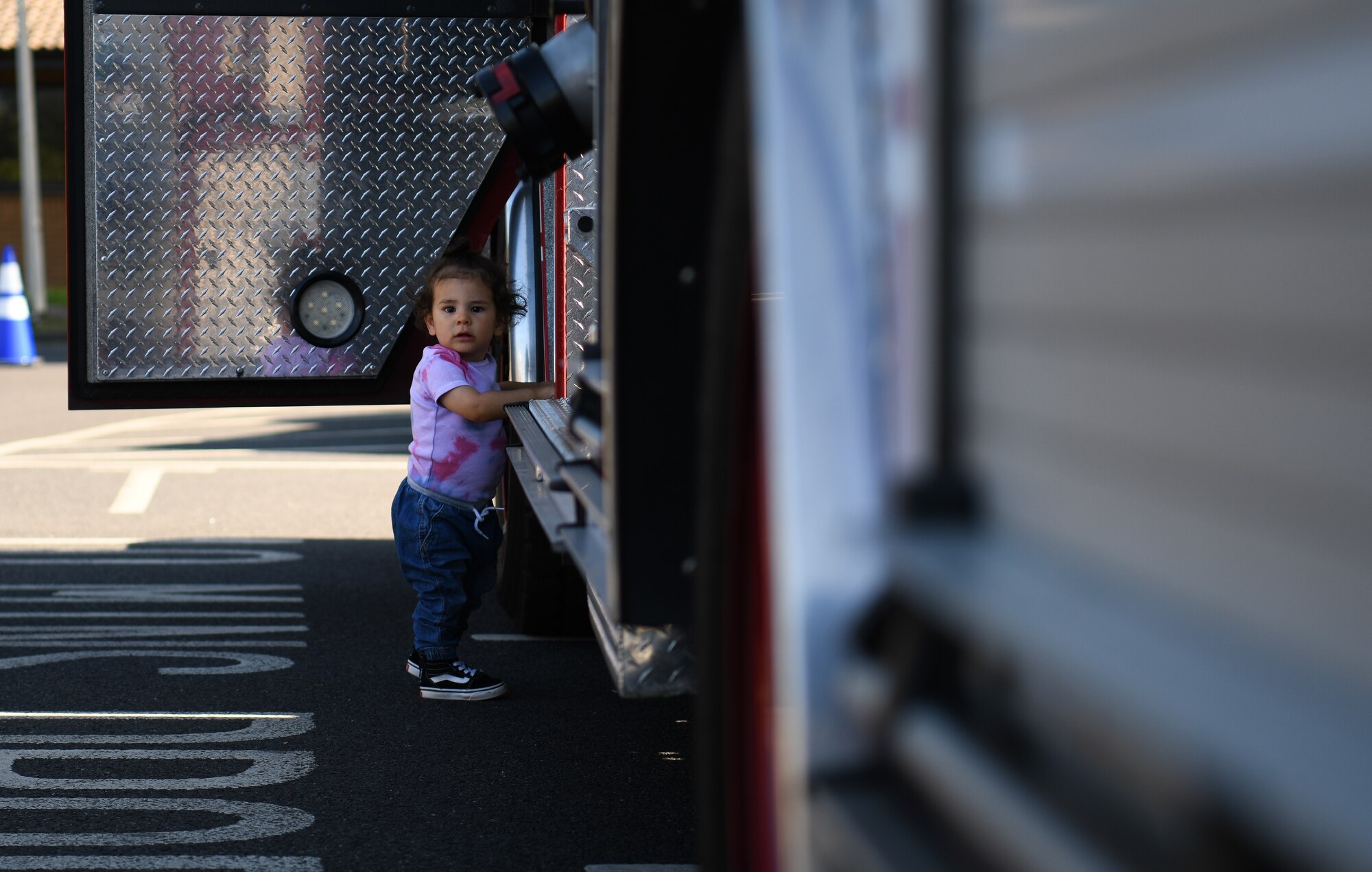 A child explores a fire engine assigned to the 48th Civil Engineer Squadron during an interactive vehicle display at Royal Air Force Lakenheath, England, July 3, 2019. The event was hosted by the 48th Logistics Readiness squadron and also included a wrecker recovery vehicle, an all-terrain forklift, patrol vehicle, an ATV and a Humvee. (U.S. Air Force photo by Airman 1st Class Shanice Williams-Jones)