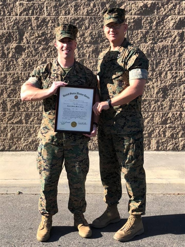 U.S. Marine Maj. Thomas Driscoll, commanding officer, Recruiting Station Sacramento, congratulates, Staff Sgt. Joshua Phelps on his meritorious promotion.