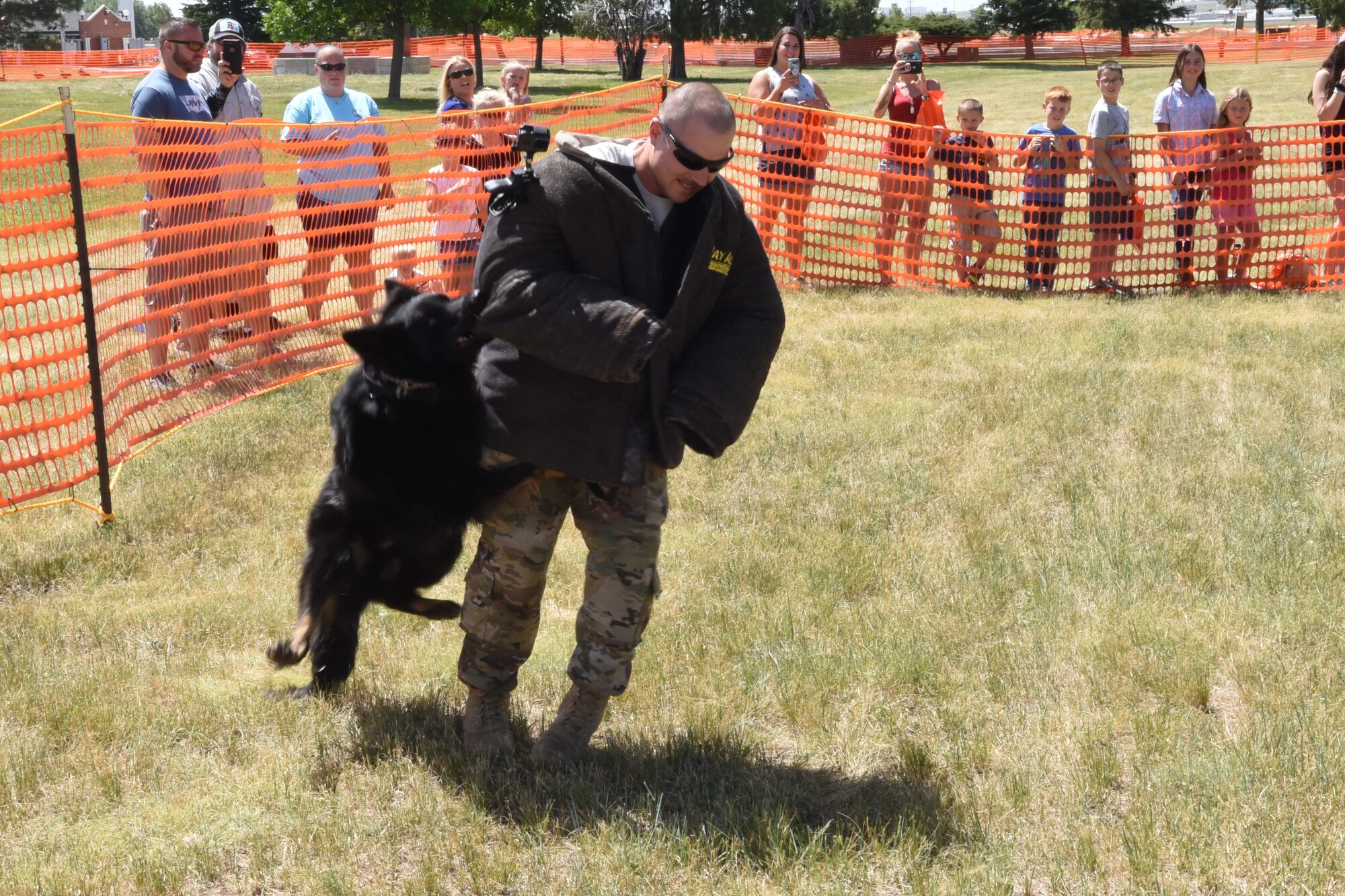 Staff Sgt. Curtis Shannon, 90th Security Forces Squadron military working dog handler, acts as non-compliant perpetrator during a K-9 exhibition at Fort D.A. Russell Days on F.E. Warren Air Force Base, Wyo., July 19, 2019. The open house gives the community the opportunity to see the history behind the base and its role within the nation’s defense.  (U.S. Air Force photo by Terry Higgins)