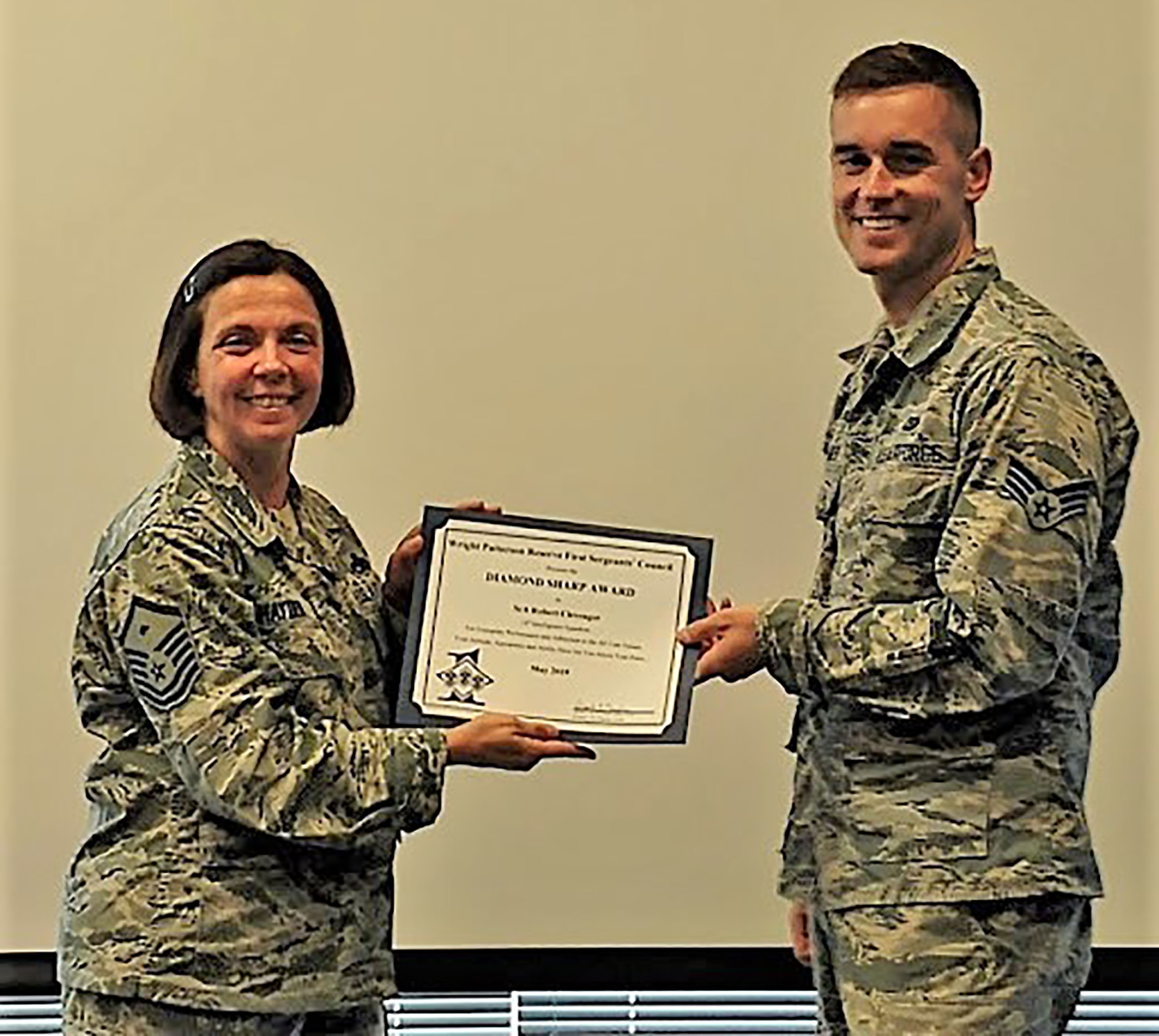 Master Sgt. Angela Hayden, 14th Intelligence Squadron first sergeant, presents the May 2019 Diamond Sharp Award to Senior Airman Clevenger, 14th Intelligence Squadron, during the July 2019 unit training assembly. The award is for exemplary performance, adherence to the Air Force Core Values, attitude, appearance and ability.