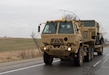 Soldiers from the 1168th Transportation Company transport an FMTV (Family of Medium Tactical Vehicles) from the Forward Support Company, 224th Engineer Battalion, to be decommissioned March 12.